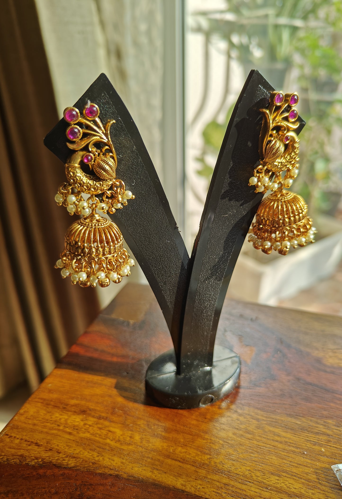 Padmavati Temple set in a gold finish with a Lakshmi pendant, peacock motif all around necklace