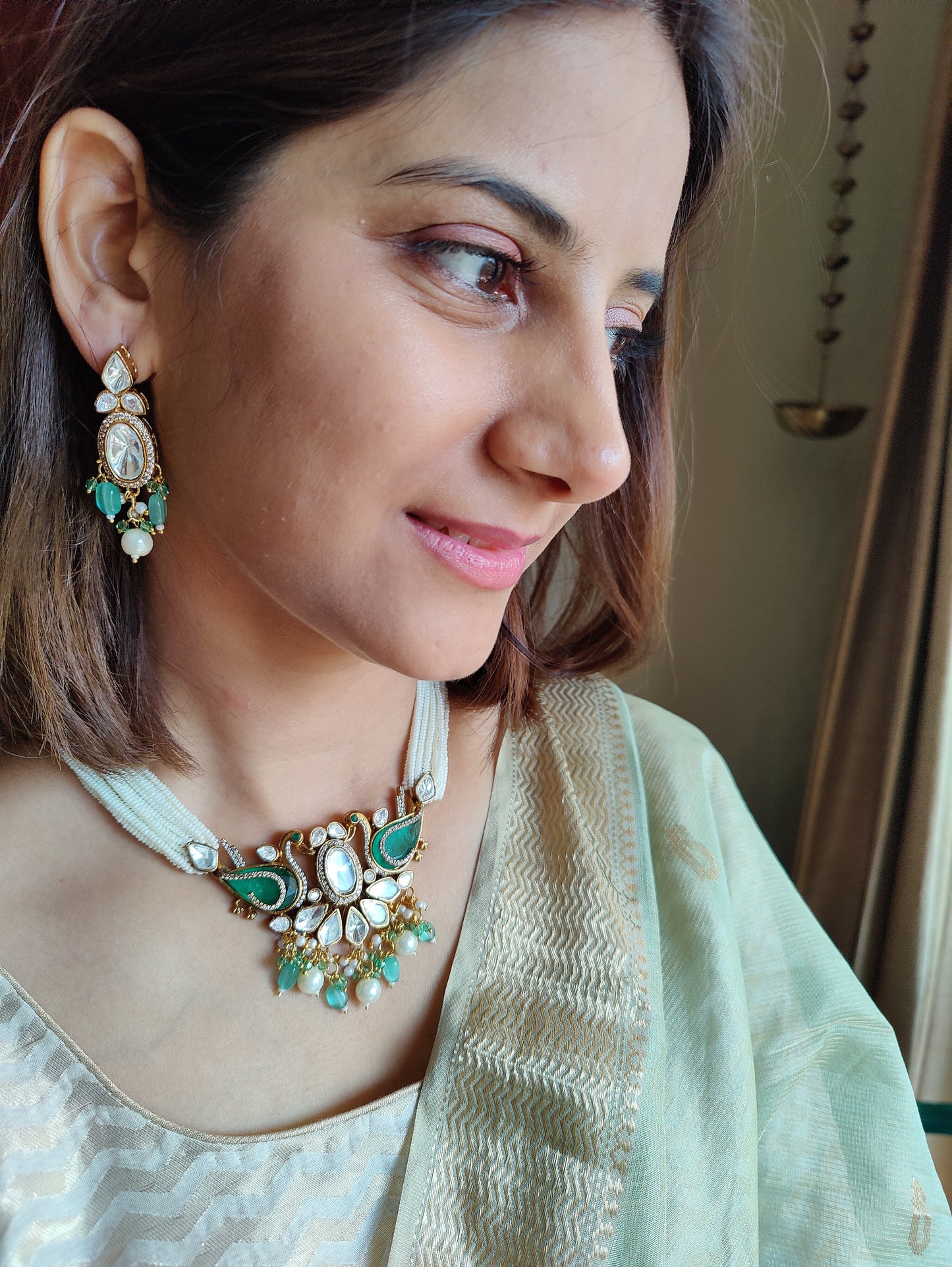 Deepta set with peacocks and moissanite on poth pearl strings