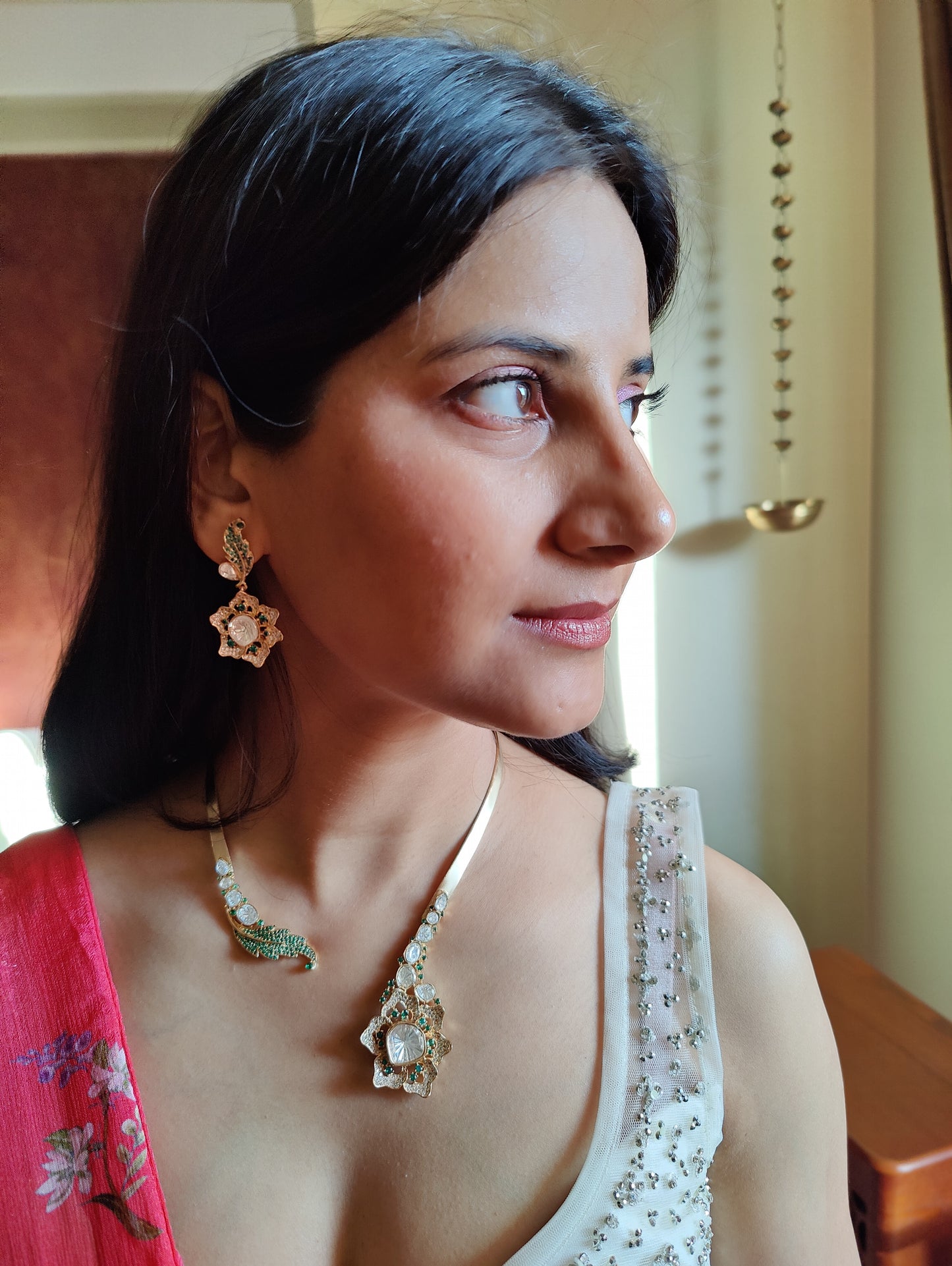 Hemlata gold hastli with kundan and emerald green stones