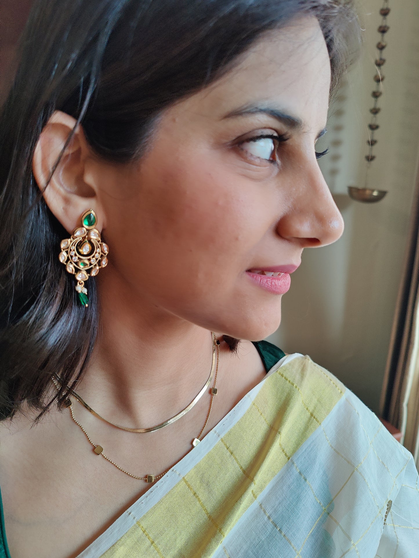 Chhabi earrings with kundan and emerald green stone