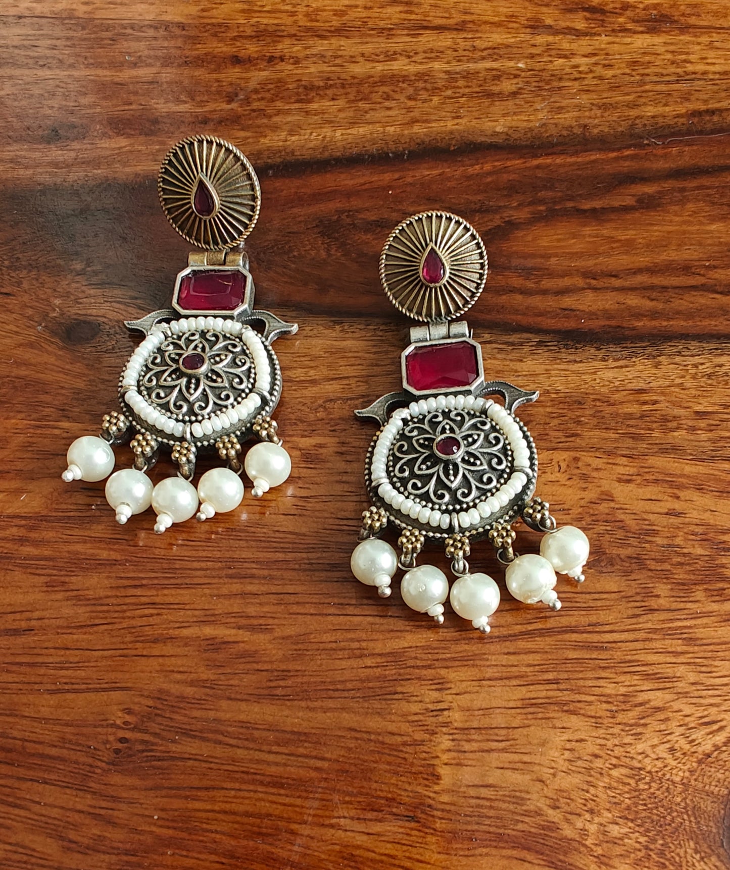 Dual tone earrings with stone and pearl edging