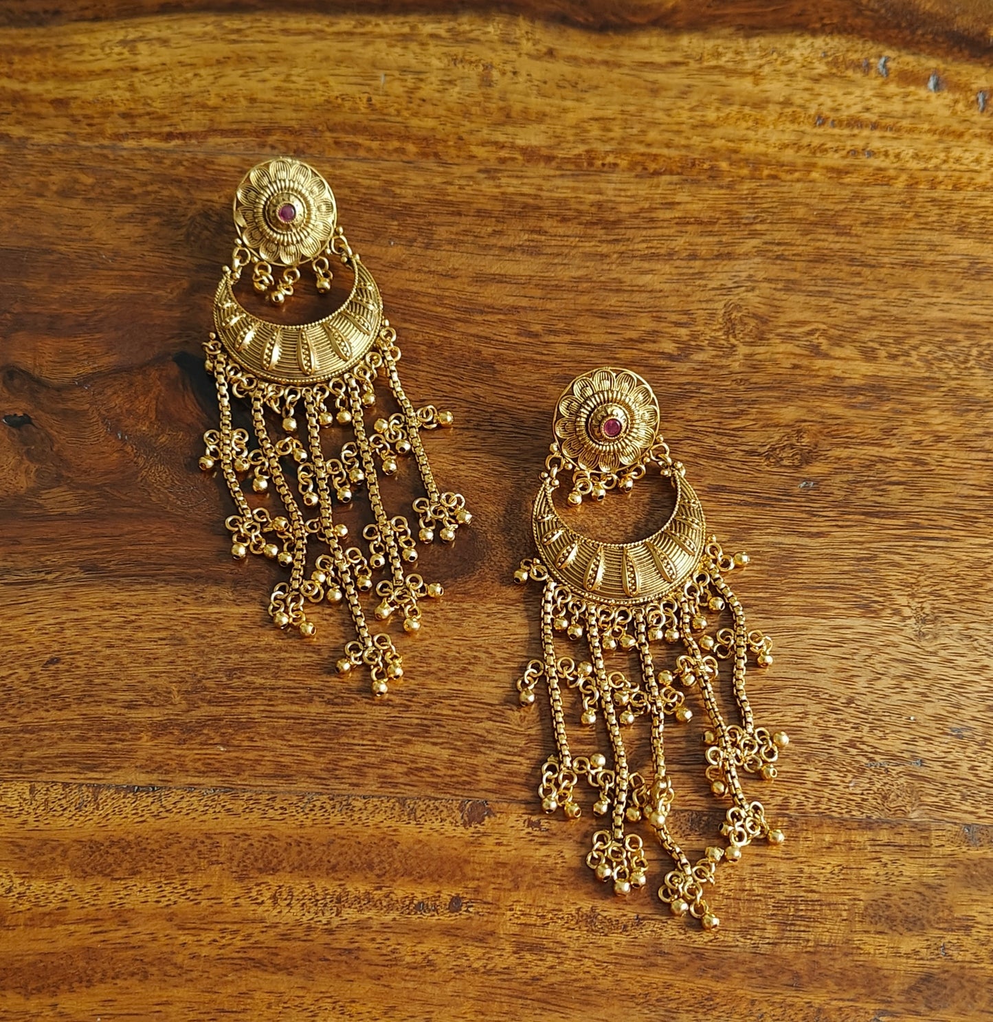 Gold earrings with gold ball hangings on five chains