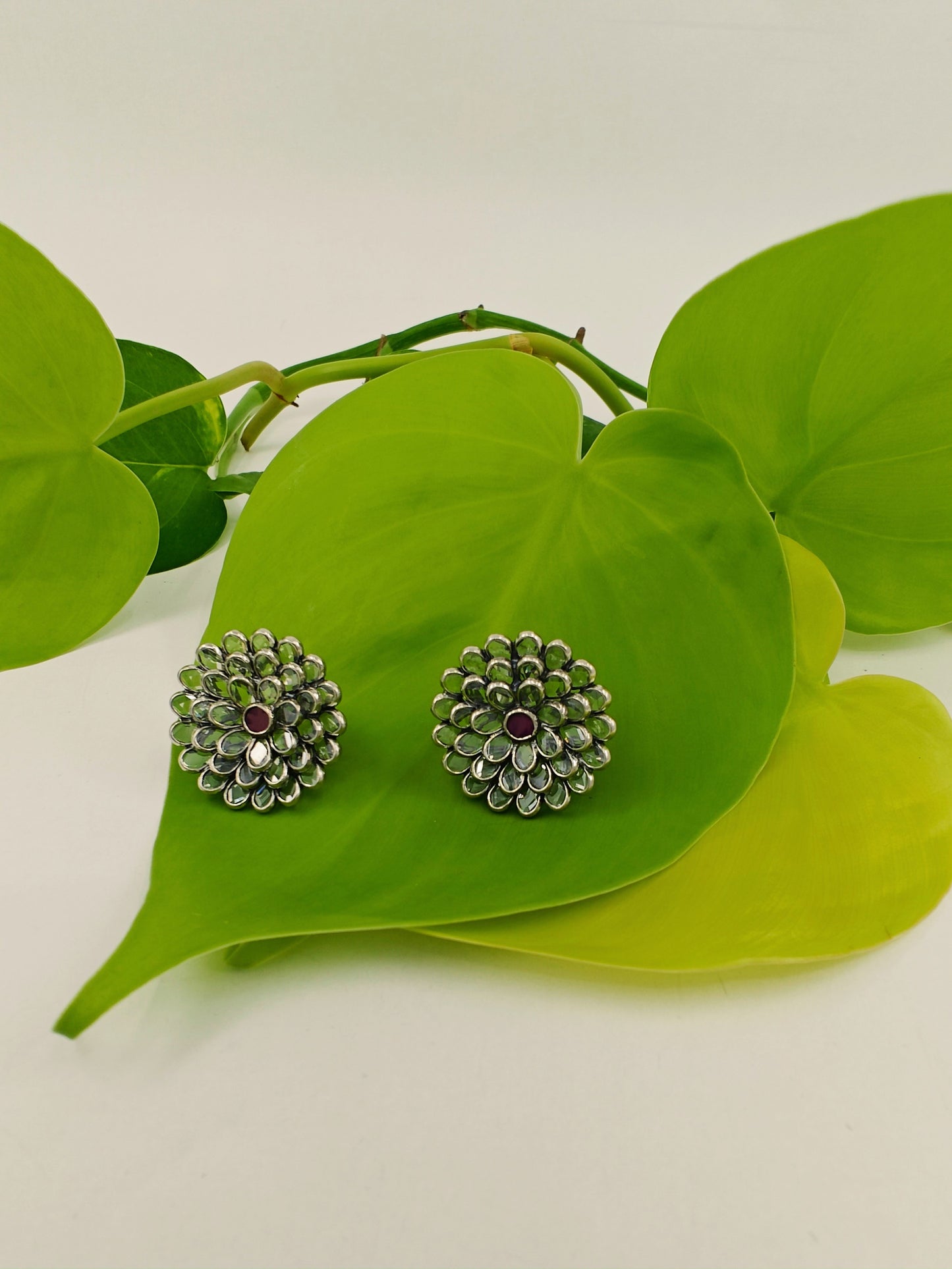 Silver earrings in open flower motif with clear stones