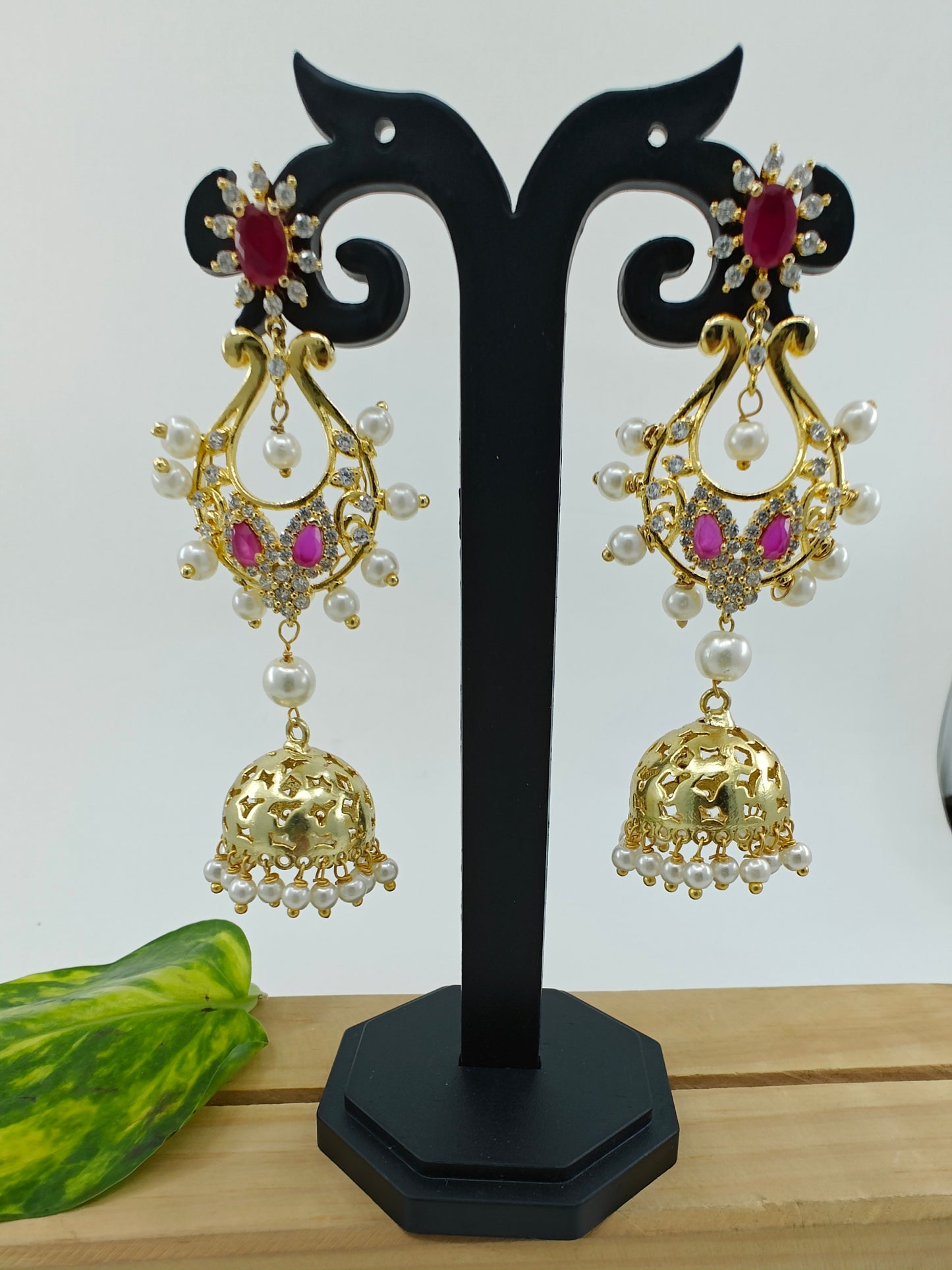 Golden jhumkis(earrings) with pink stone and pearls
