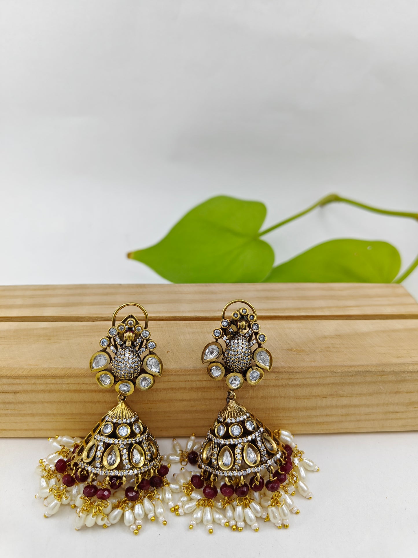Antique jhumkas with Kundan and peacock stud,Jhumkas have kundan,pearls and red/ green stone hangings