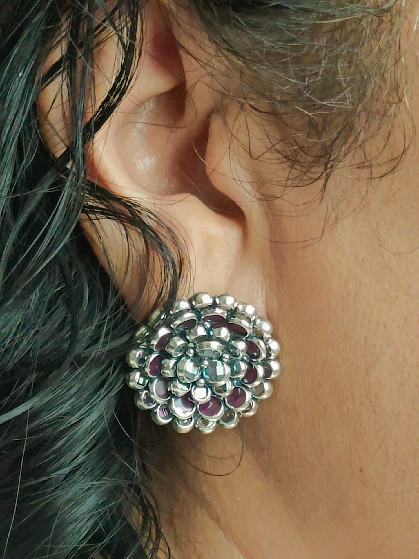 Silver stud earrings in an concentric petals floral design