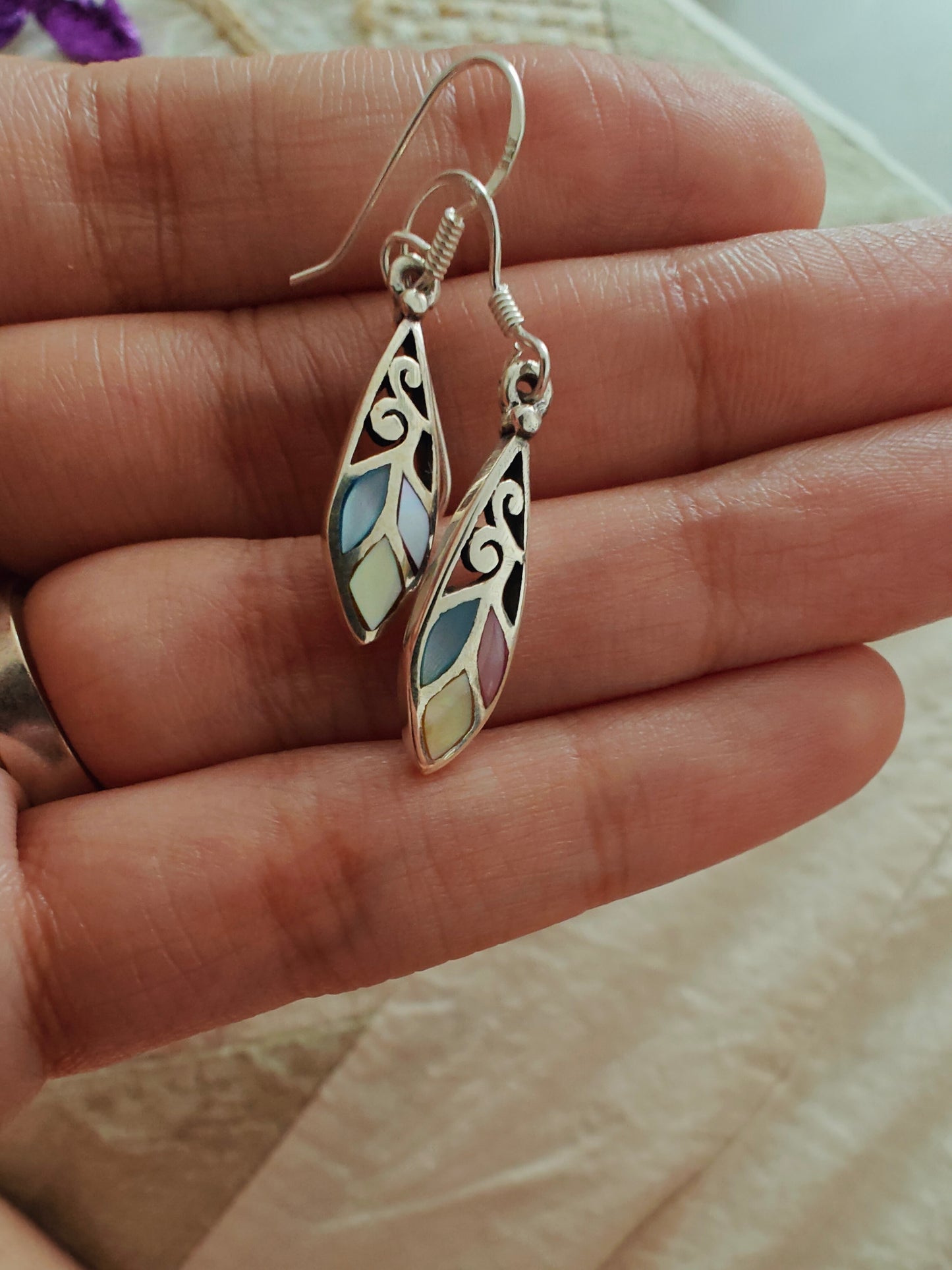 Elliptical silver earrings with carvings and pastel coloured stones