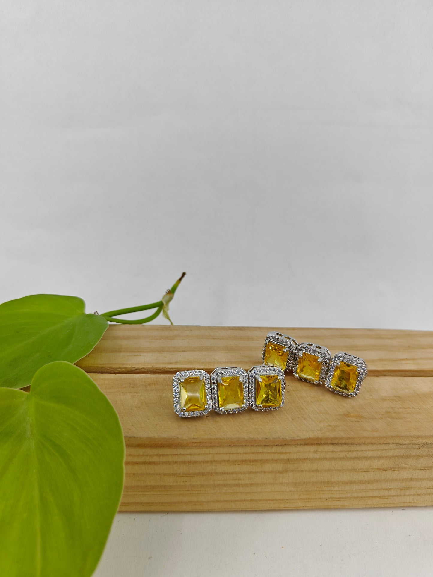 Set in platinum finish with Topaz/ Ruby red rectangular stones,matching earrings