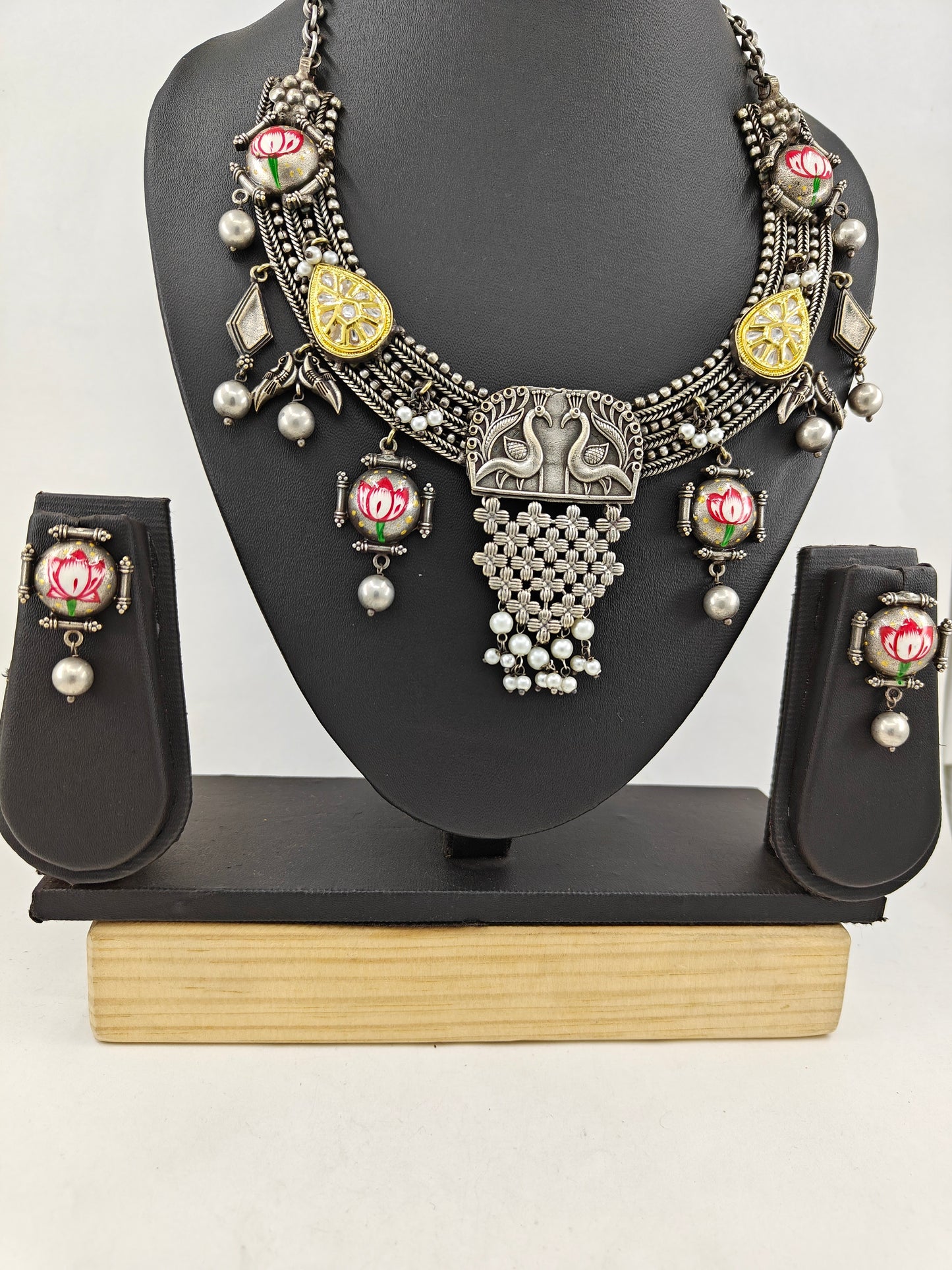 Dual tone set with painted Lotus on dome shaped pieces and peacock pendant with chattai work