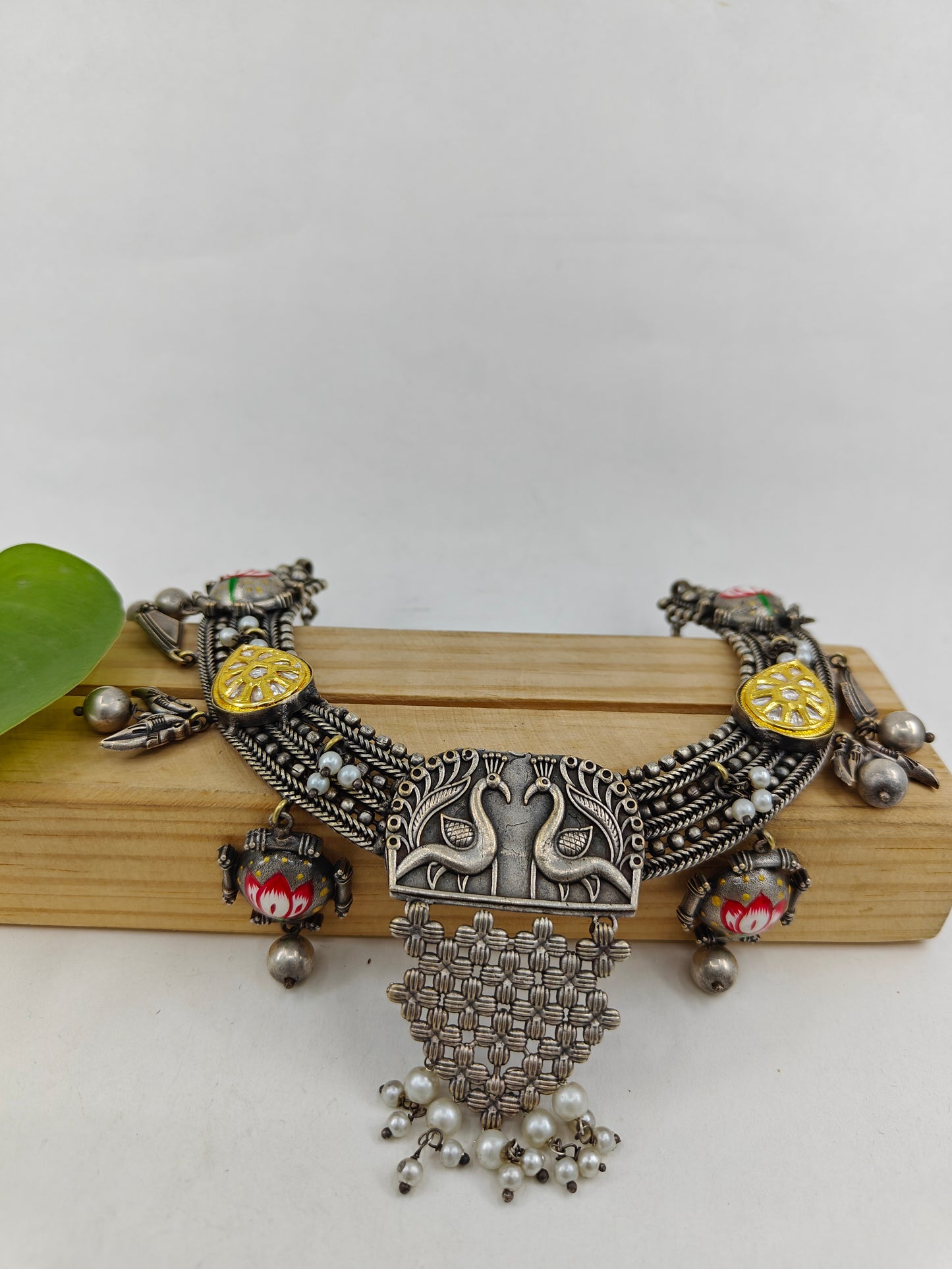 Dual tone set with painted Lotus on dome shaped pieces and peacock pendant with chattai work