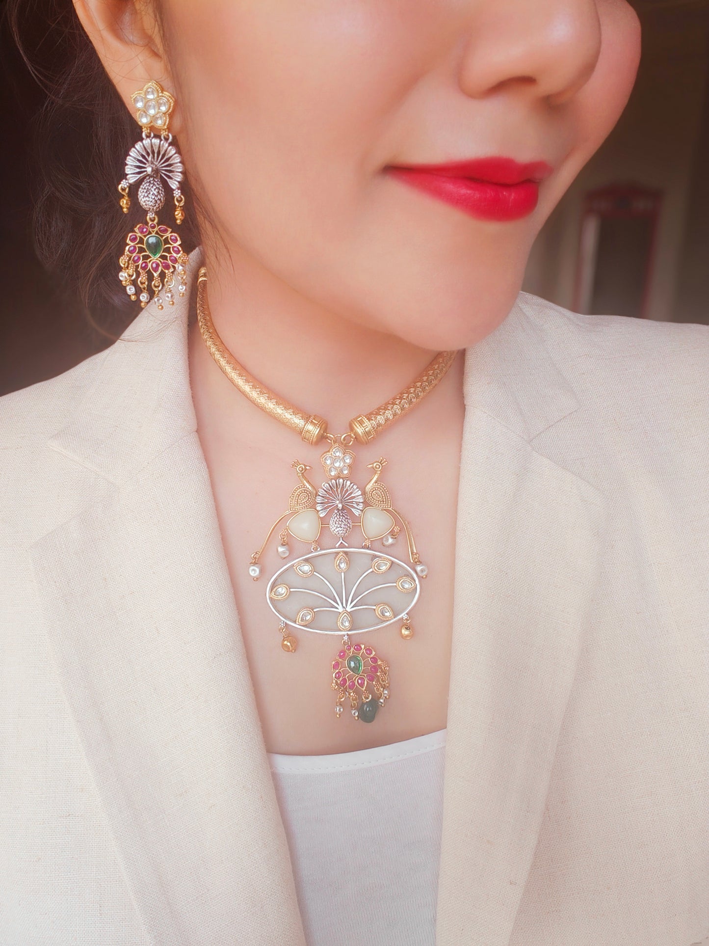 Hasli set in dual tone, pearched peacocks on stone pendant with Kundan work, matching earrings