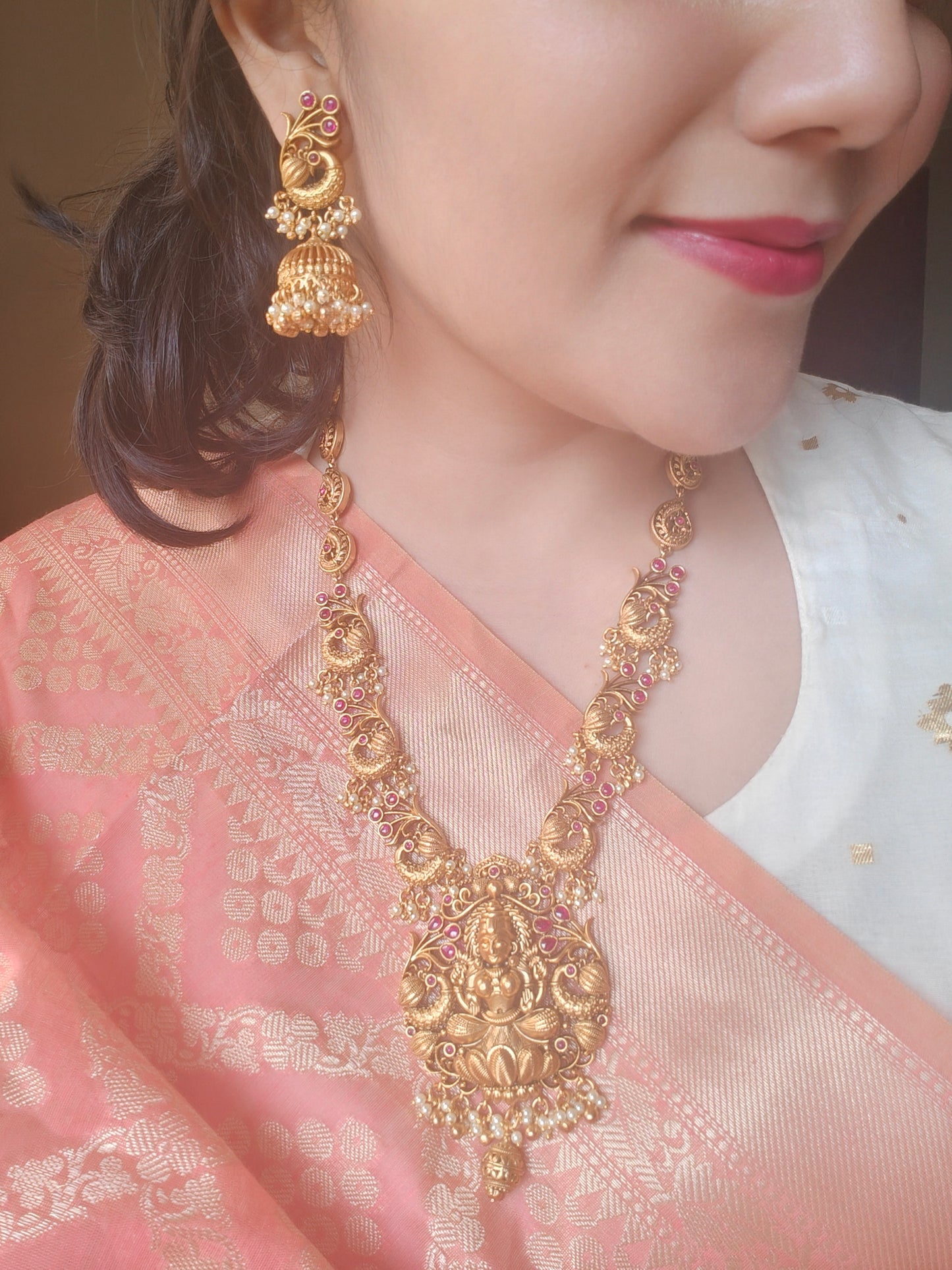 Padmavati Temple set in a gold finish with a Lakshmi pendant, peacock motif all around necklace