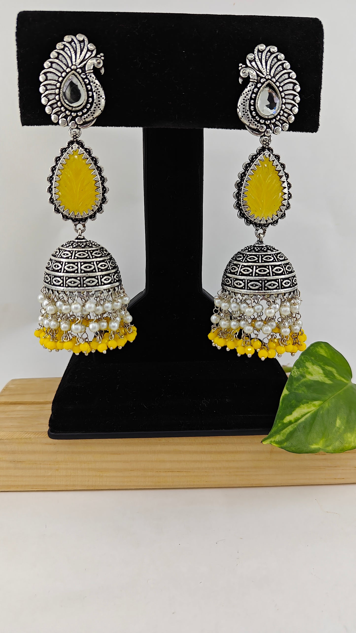 Silver finish jhumkas(earrings) with stone inlay and pearl hangings