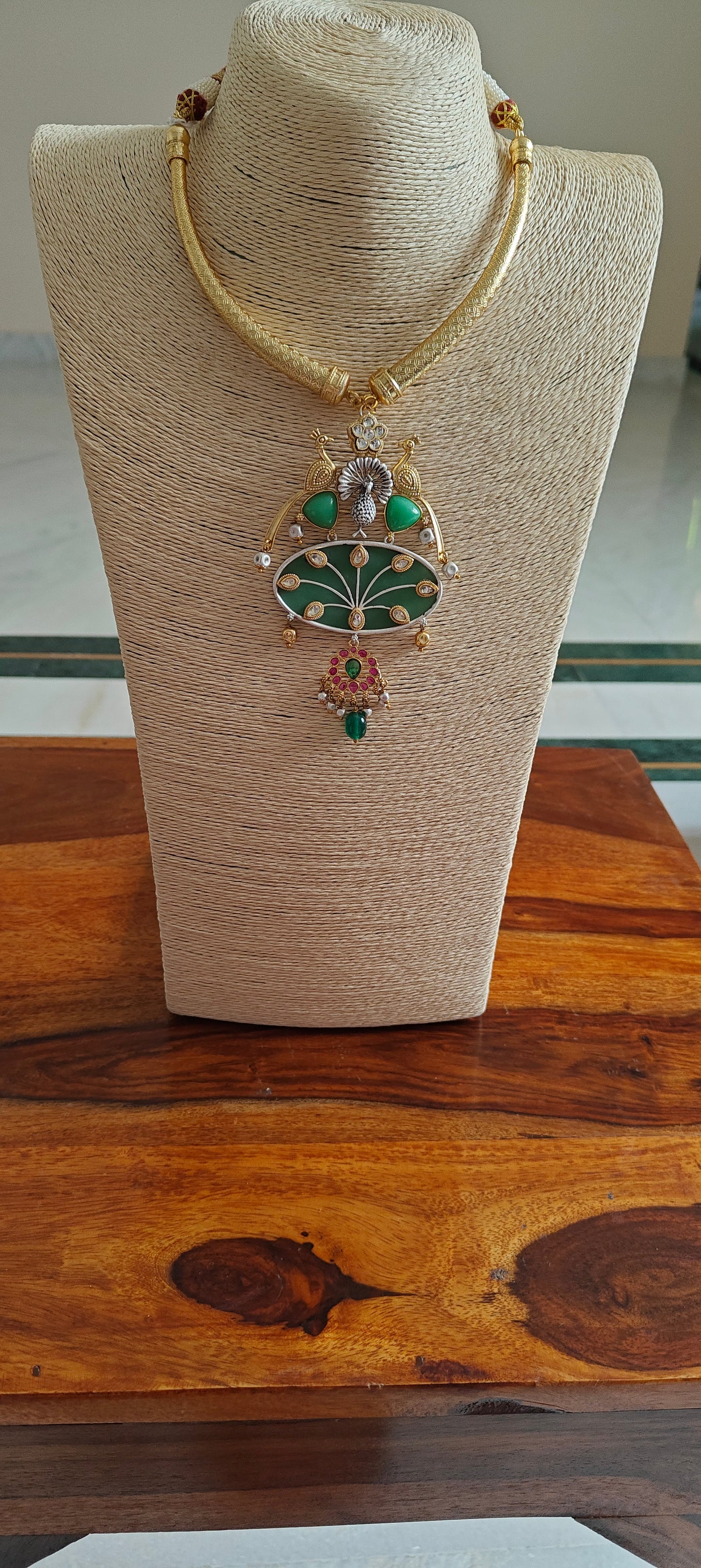 Hasli set in dual tone, pearched peacocks on stone pendant with Kundan work, matching earrings