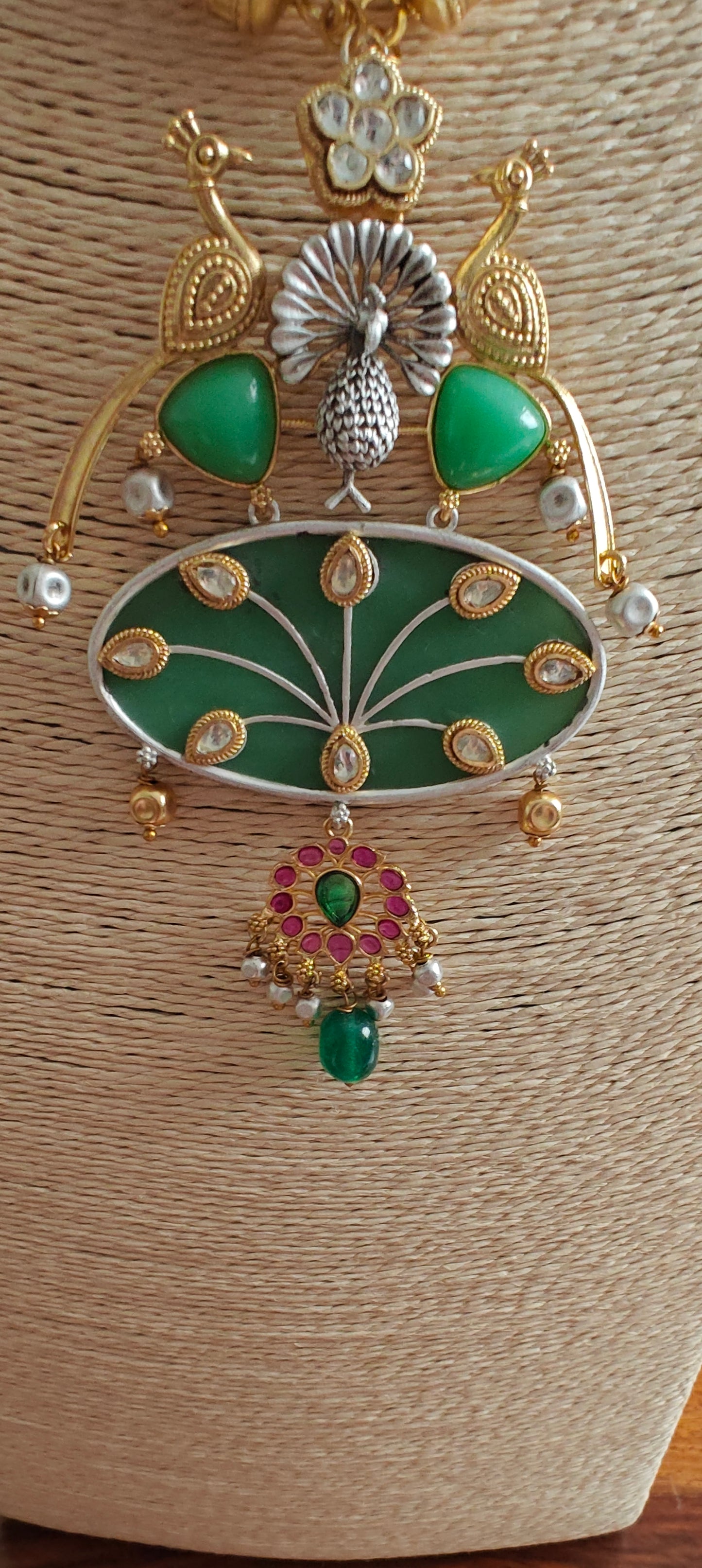 Hasli set in dual tone, pearched peacocks on stone pendant with Kundan work, matching earrings