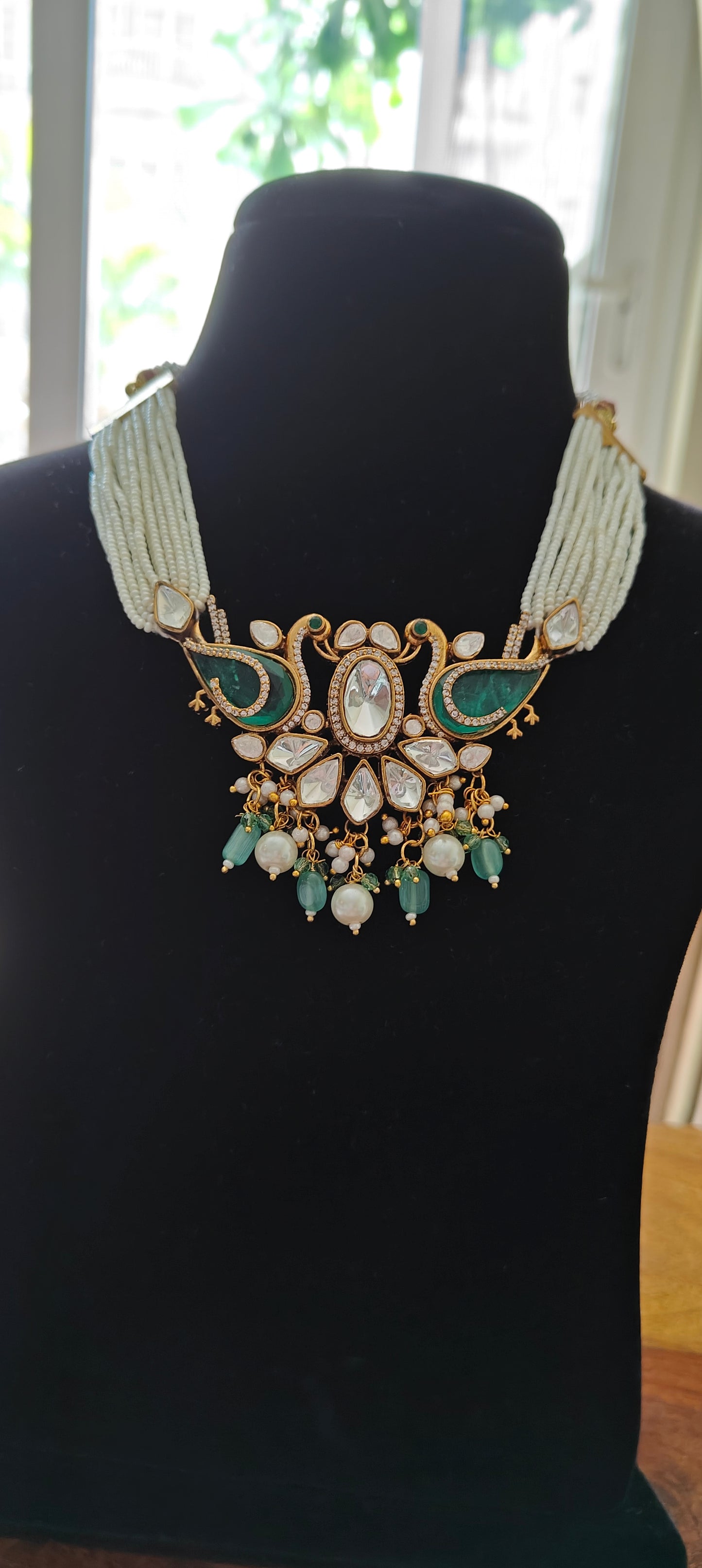 Deepta set with peacocks and moissanite on poth pearl strings