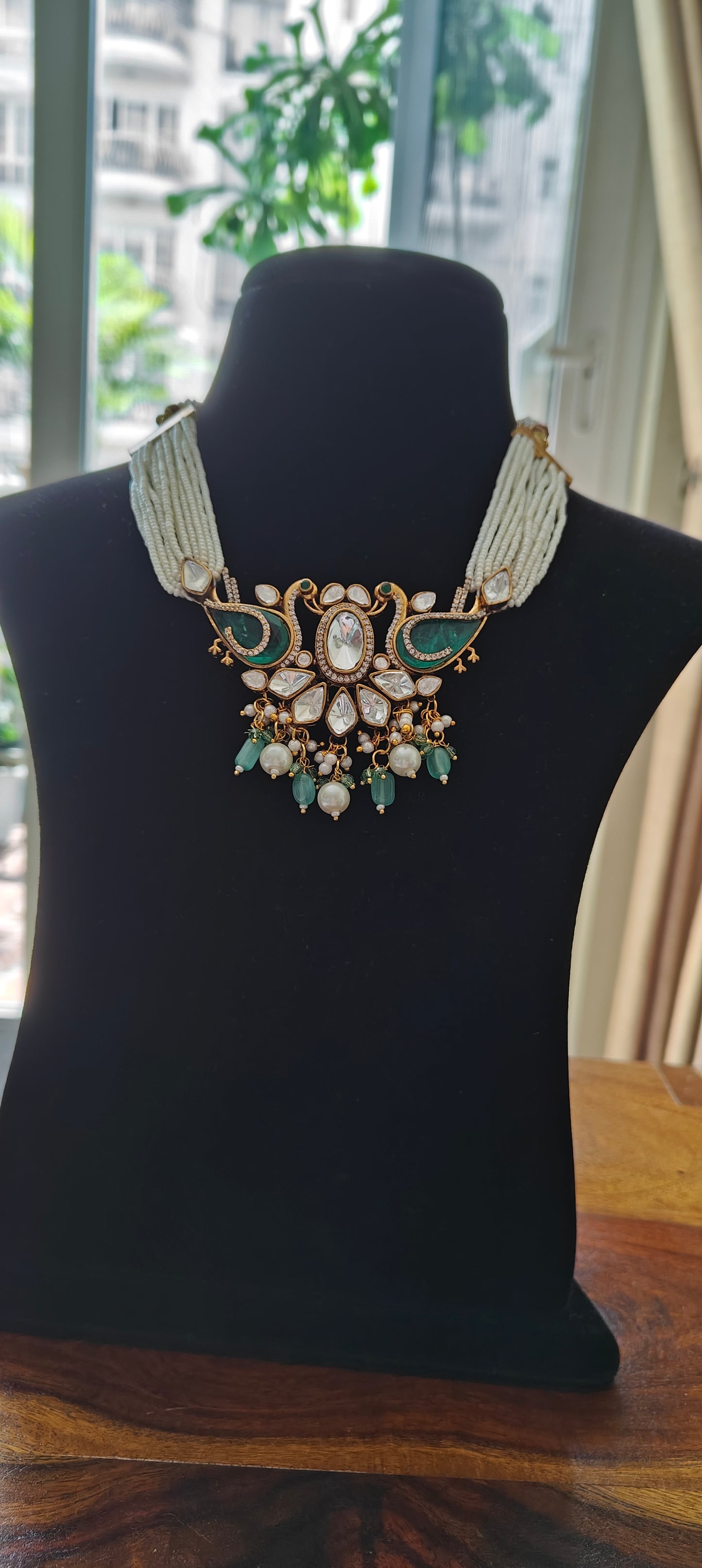 Deepta set with peacocks and moissanite on poth pearl strings
