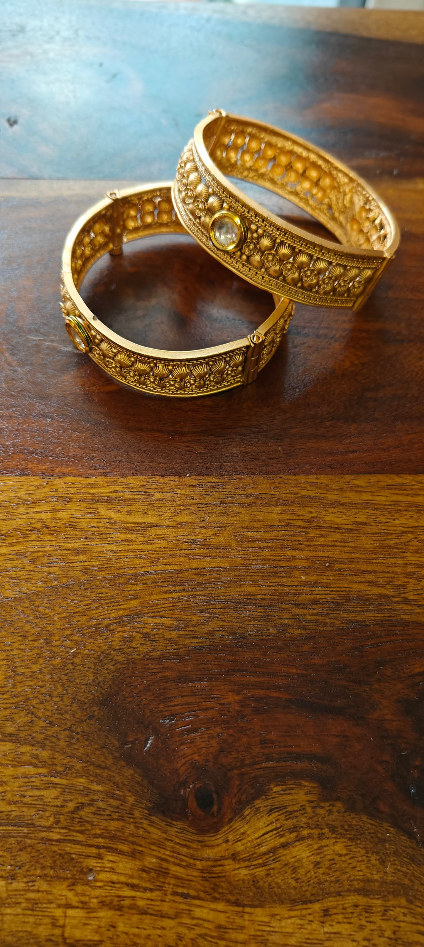 Antique golden karas with kundan and small carved flowers