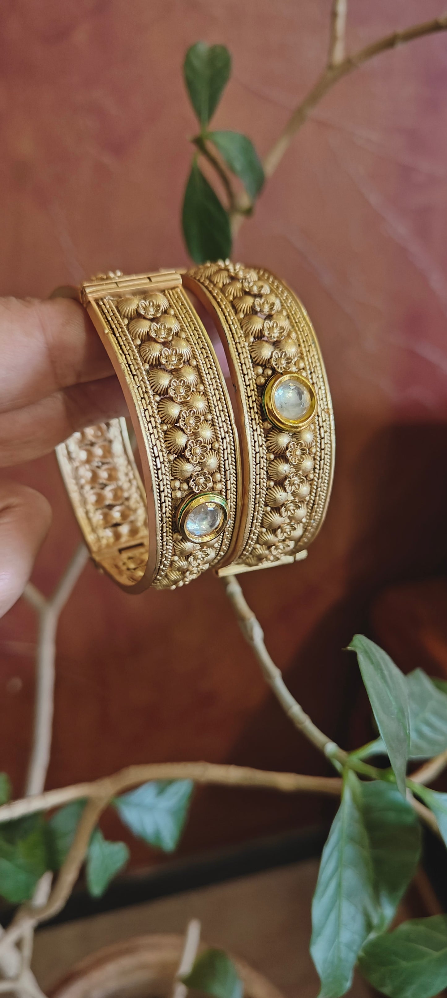 Antique golden karas with kundan and small carved flowers