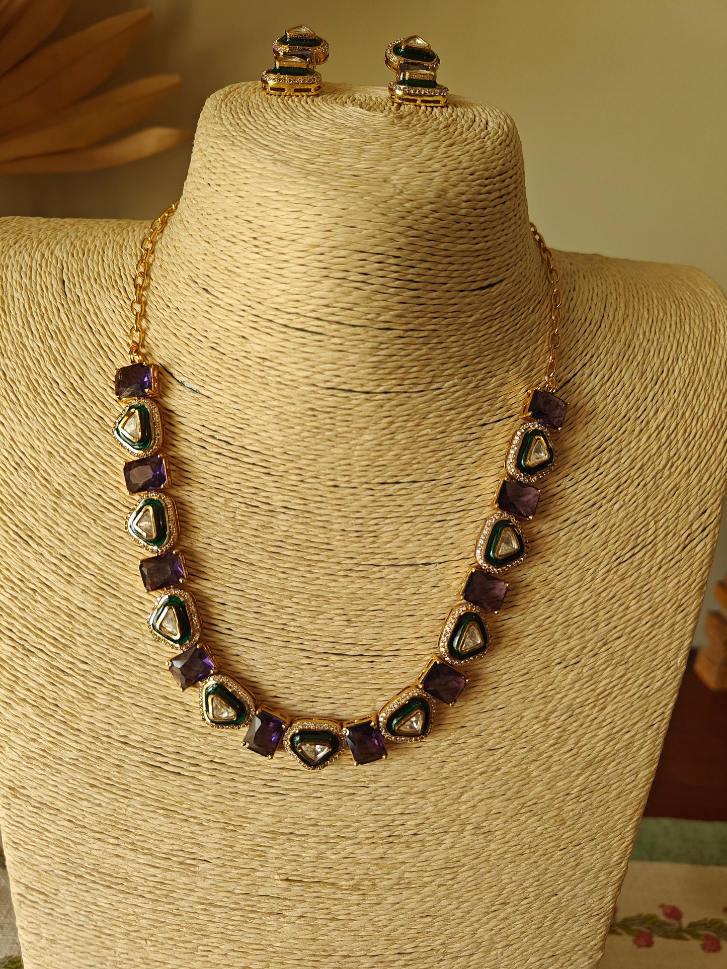 Eka set with stones alternating with triangular kundan pieces with meenakari