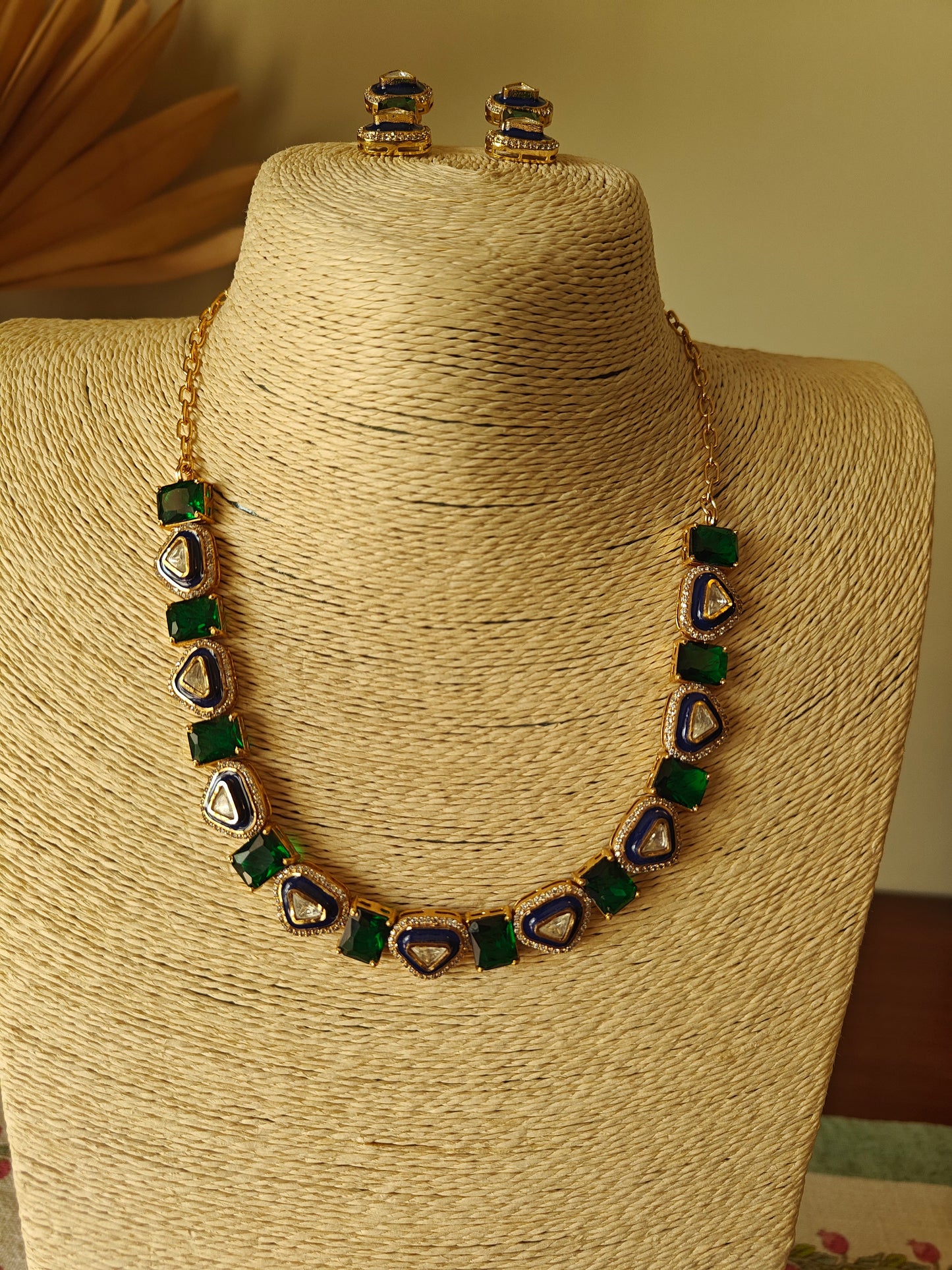 Eka set with stones alternating with triangular kundan pieces with meenakari