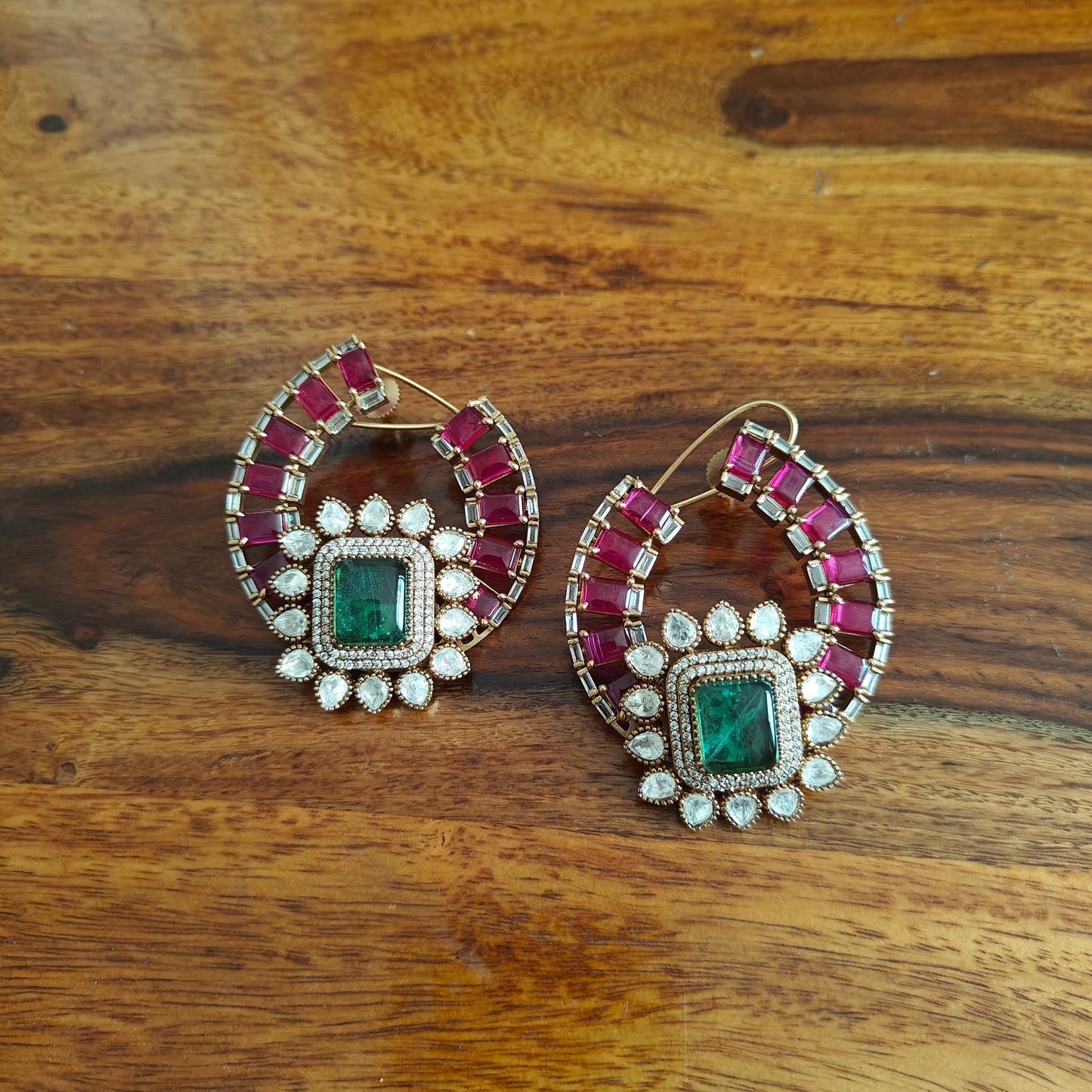 Elaborate earrings with ruby and emerald green stone