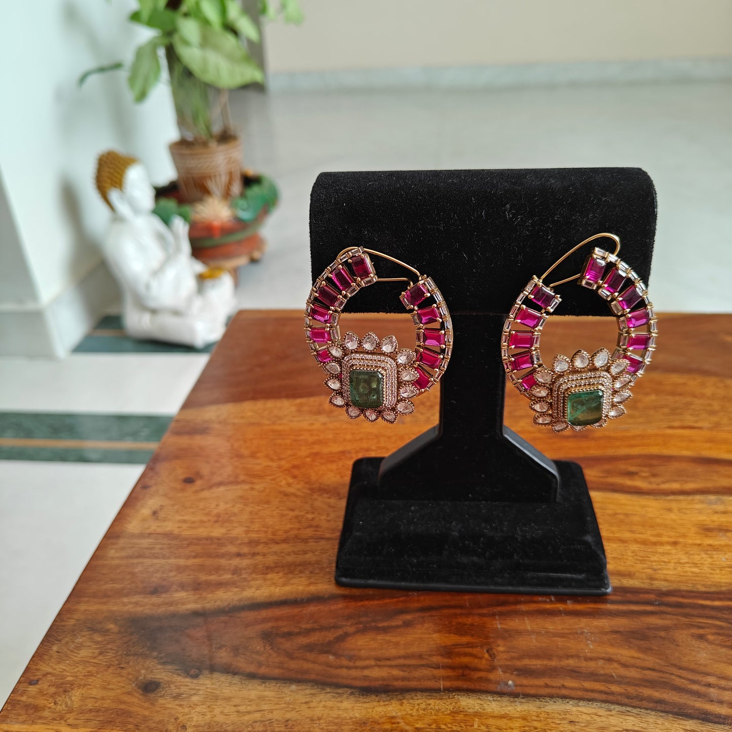 Elaborate earrings with ruby and emerald green stone