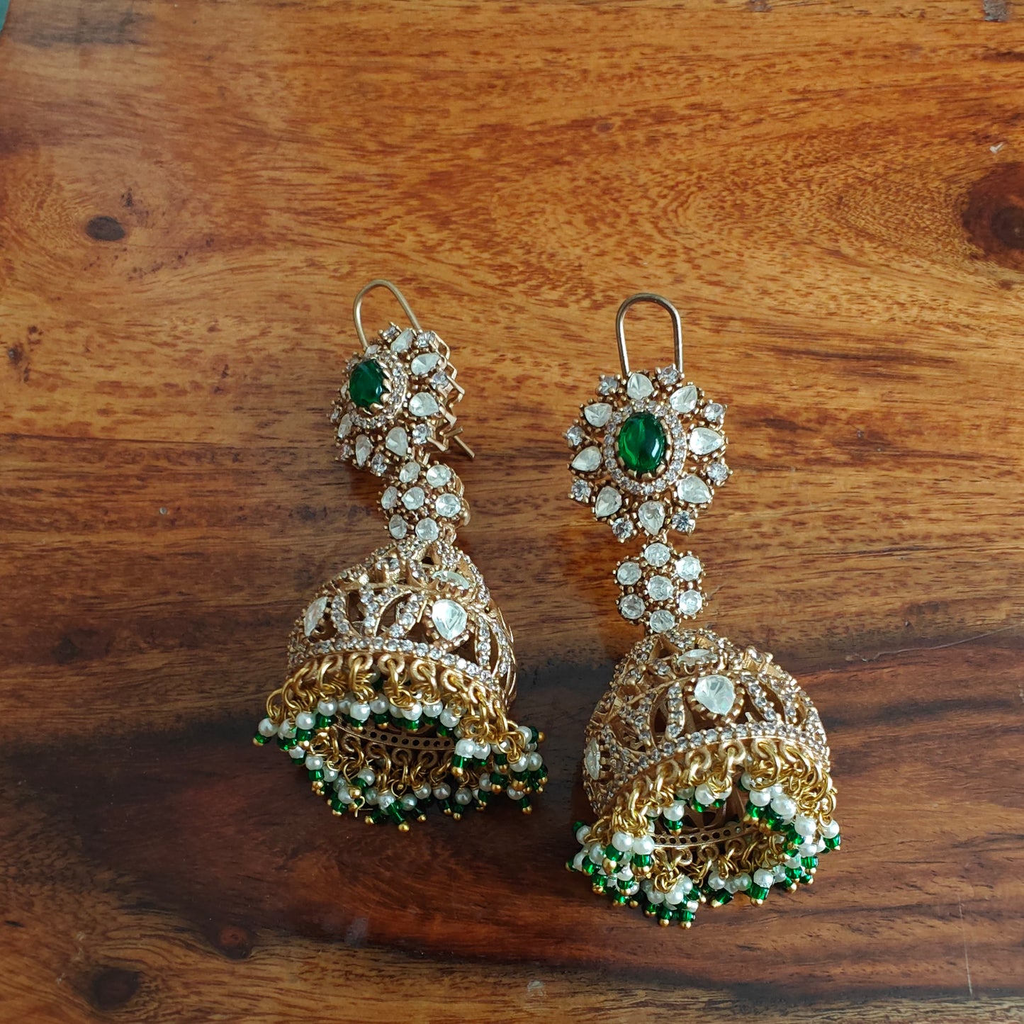 Long jhumkis with moissanite and emerald green stone