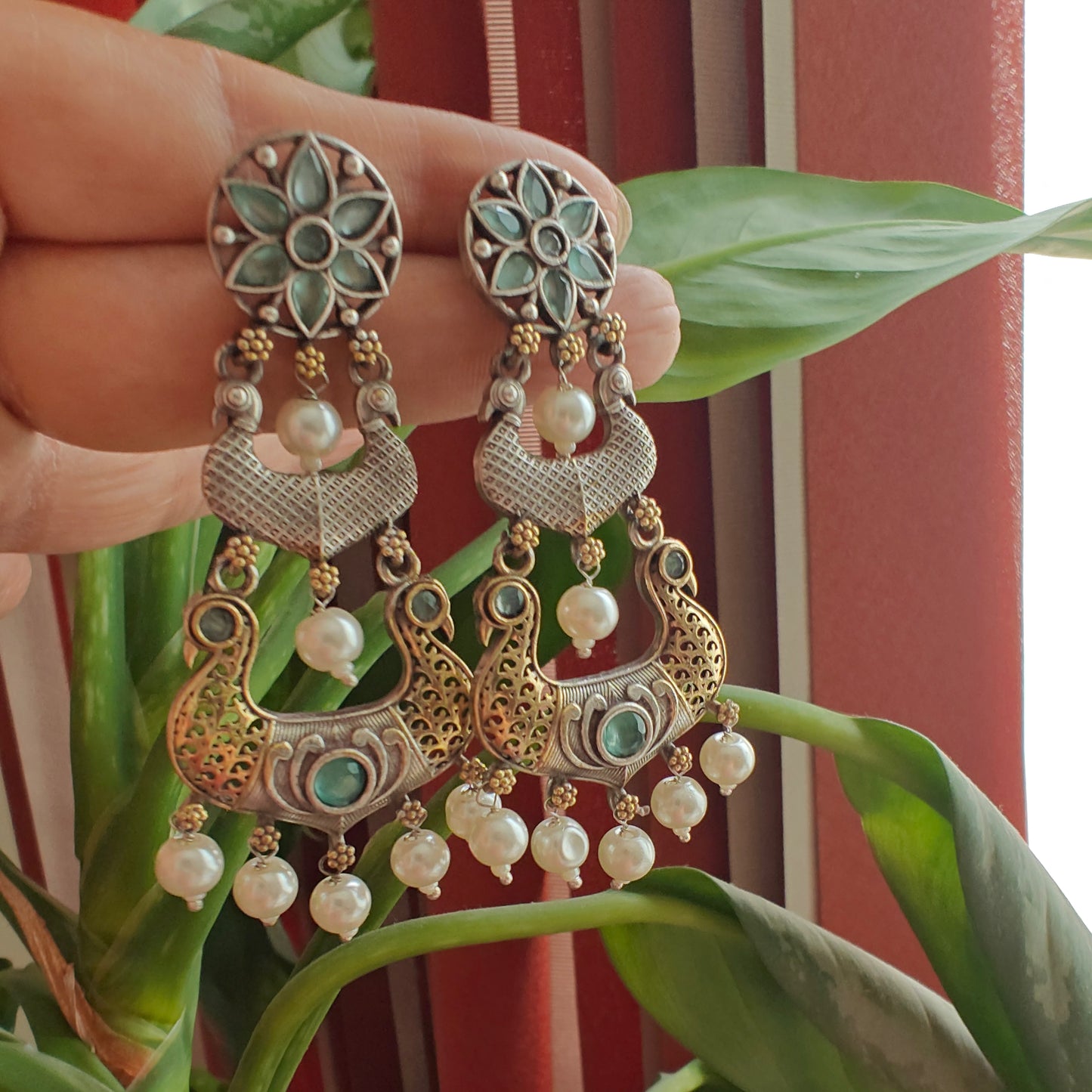 Dual tone earrings with peacocks and stone
