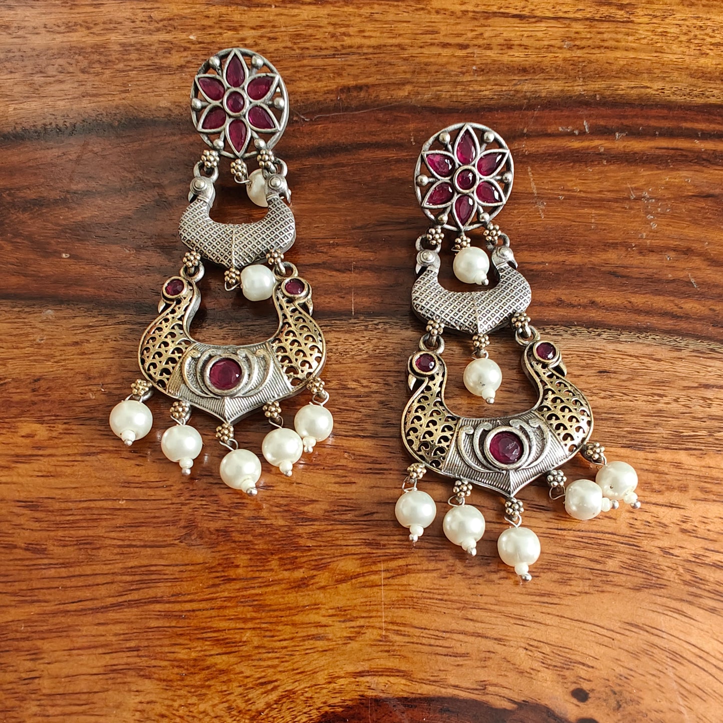 Dual tone earrings with peacocks and stone