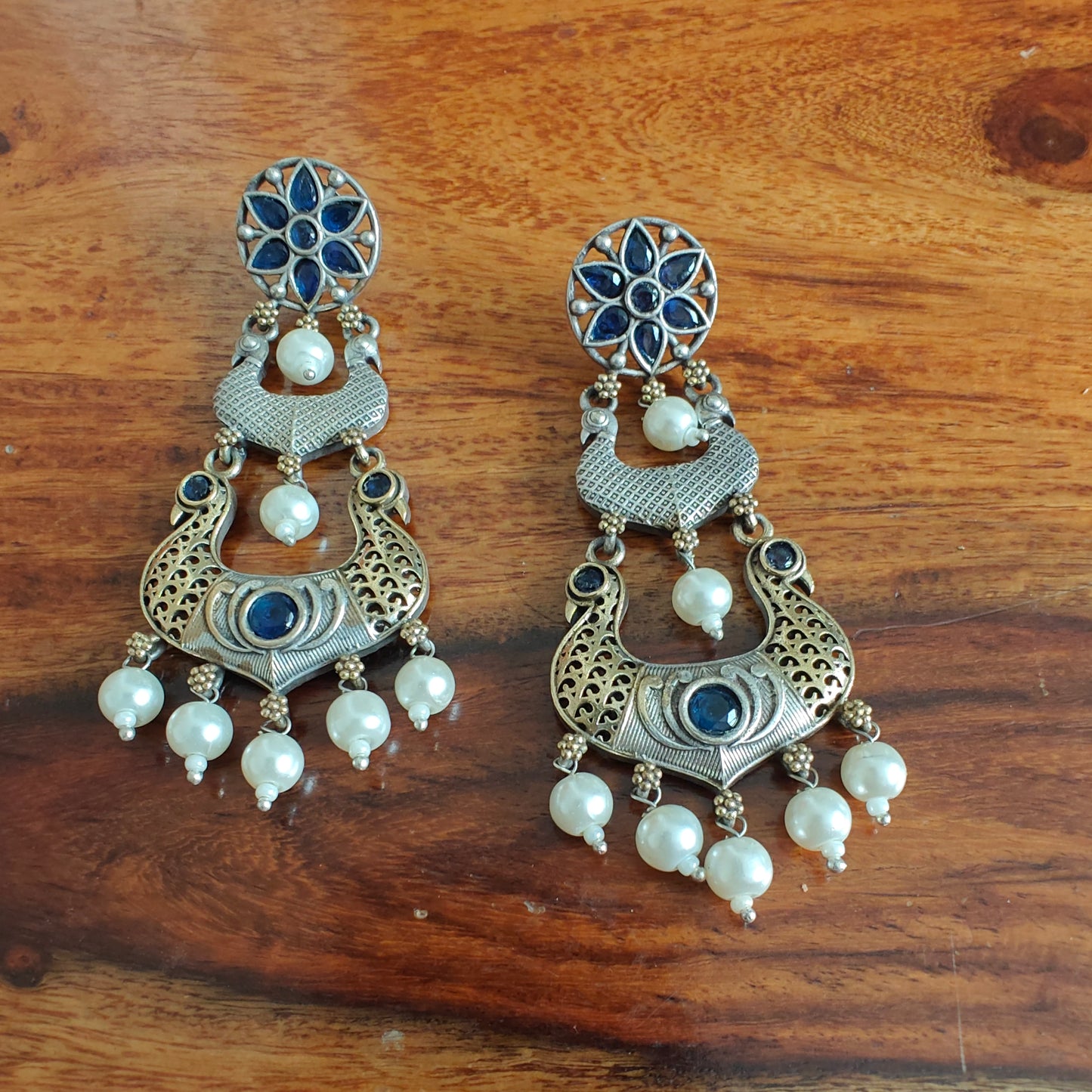 Dual tone earrings with peacocks and stone