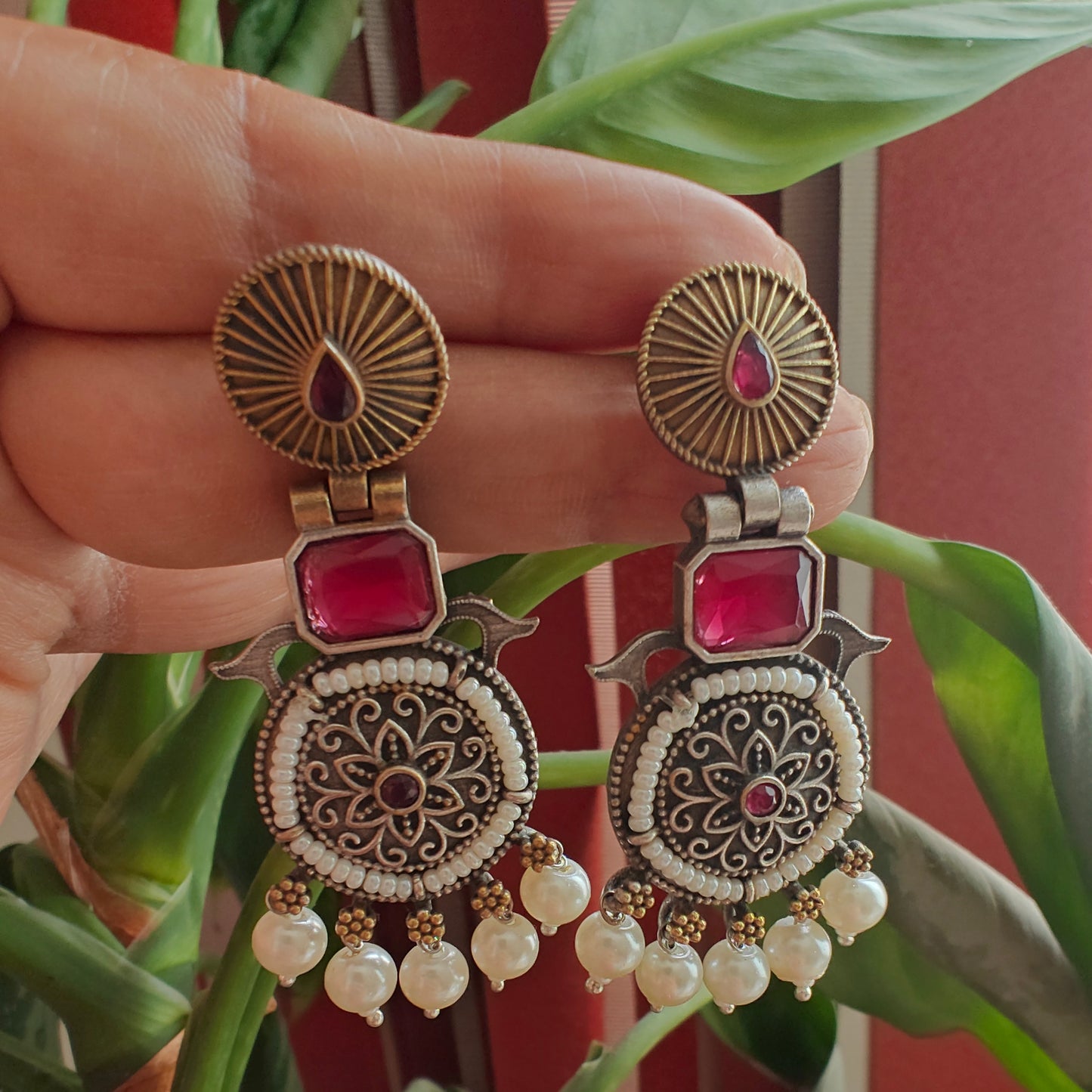 Dual tone earrings with stone and pearl edging