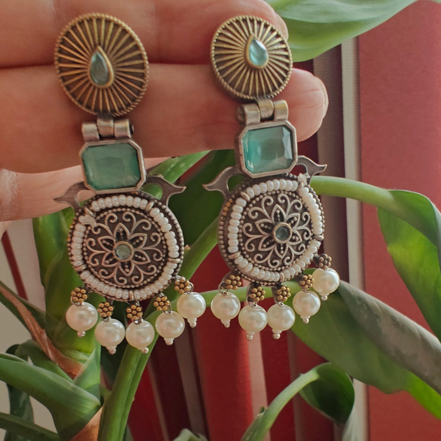 Dual tone earrings with stone and pearl edging