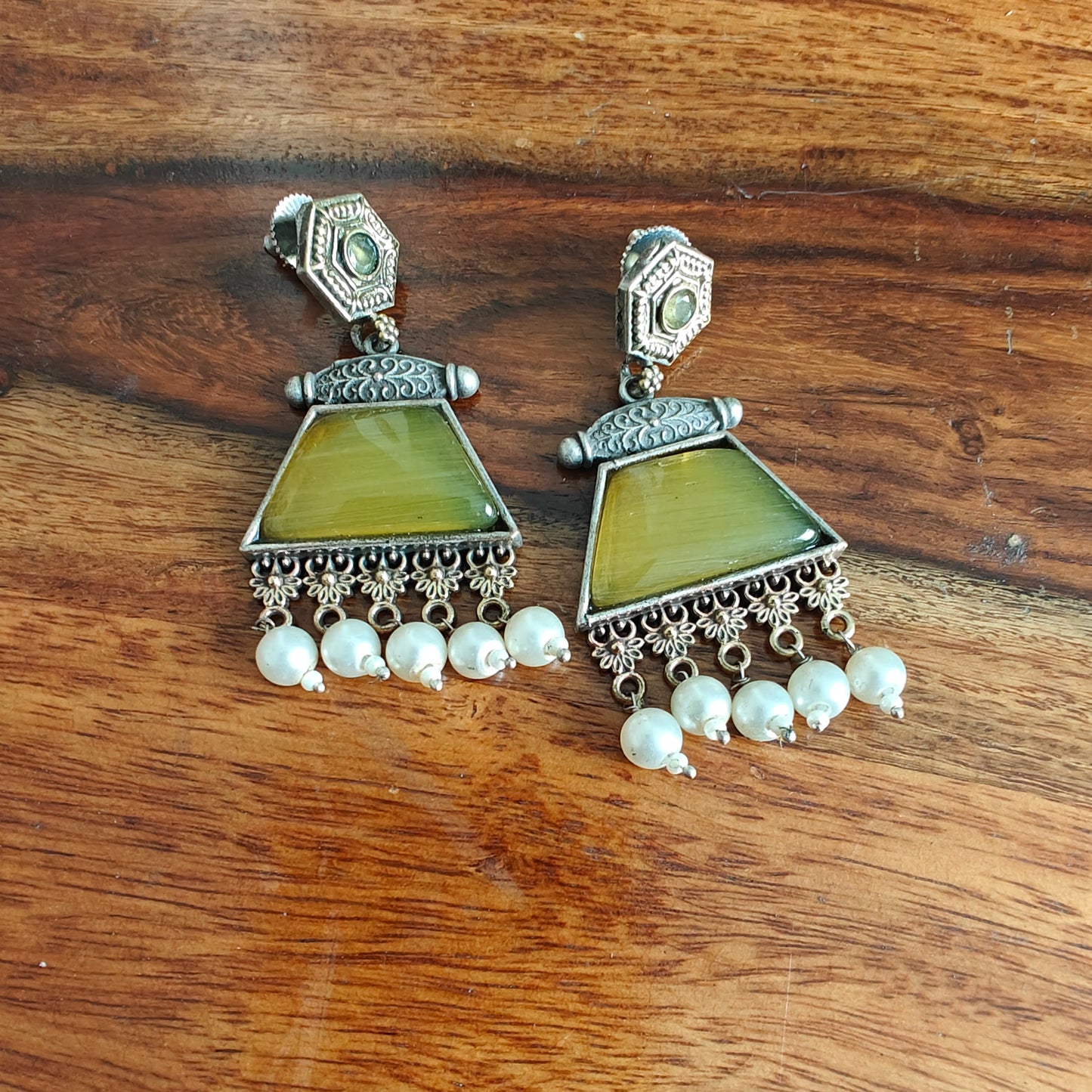 Dual tone earrings with coloured stone