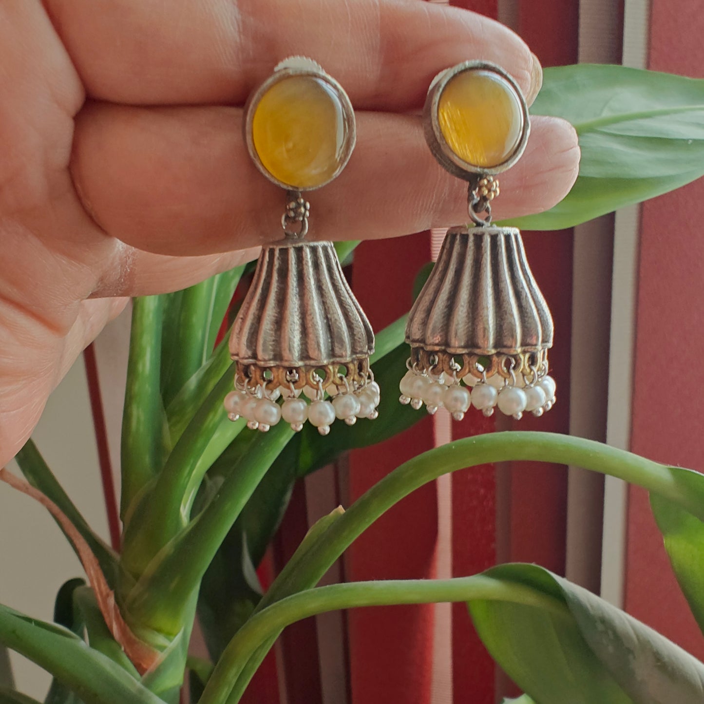 Dual tone jhumkis with yellow stone stud