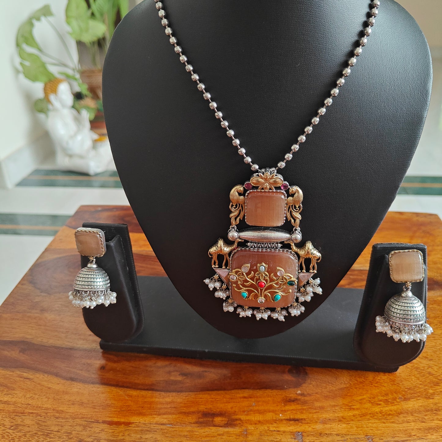 Dual tone set with stone pendant with work and stones on top