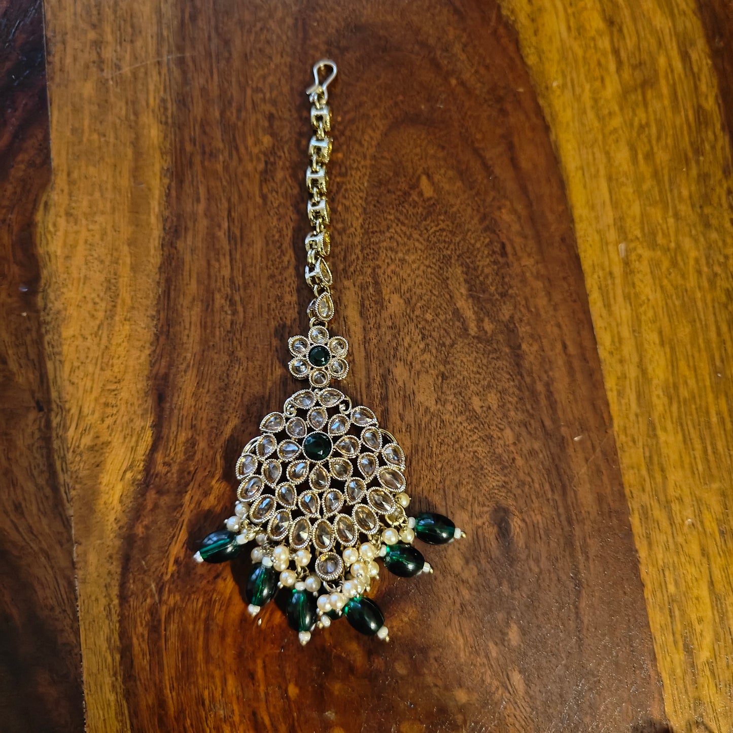 Big stone jhumkis(earrings),pearl chains,mang tikka