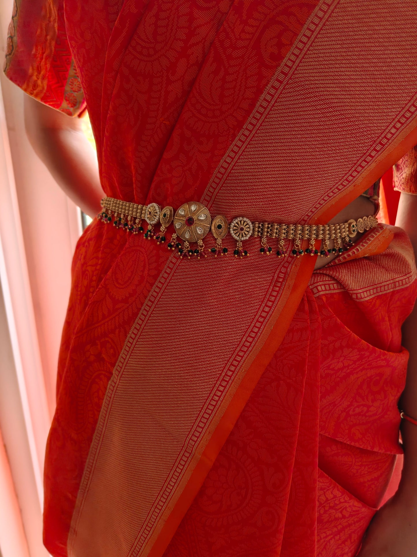Golden belt with central round piece with kundan and stones hangings all over