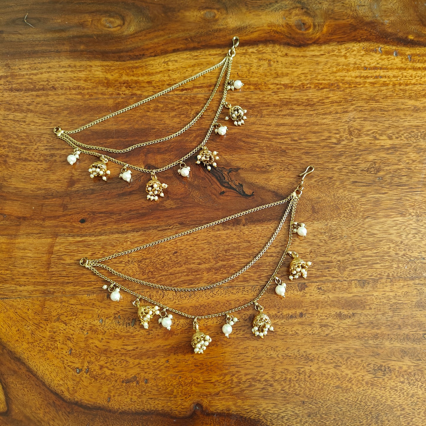 Antique gold finish earchains with jhumkis pearl clusters