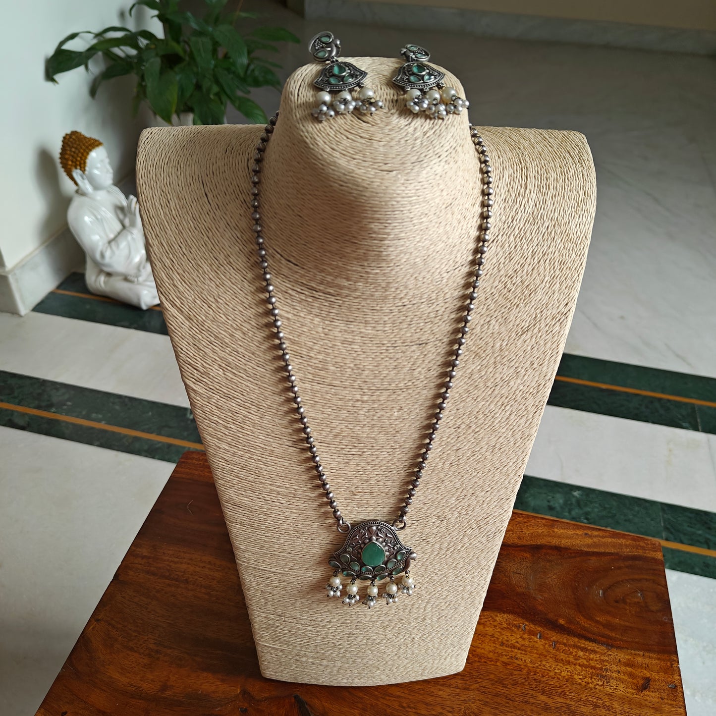 Set with peacock motif and stones