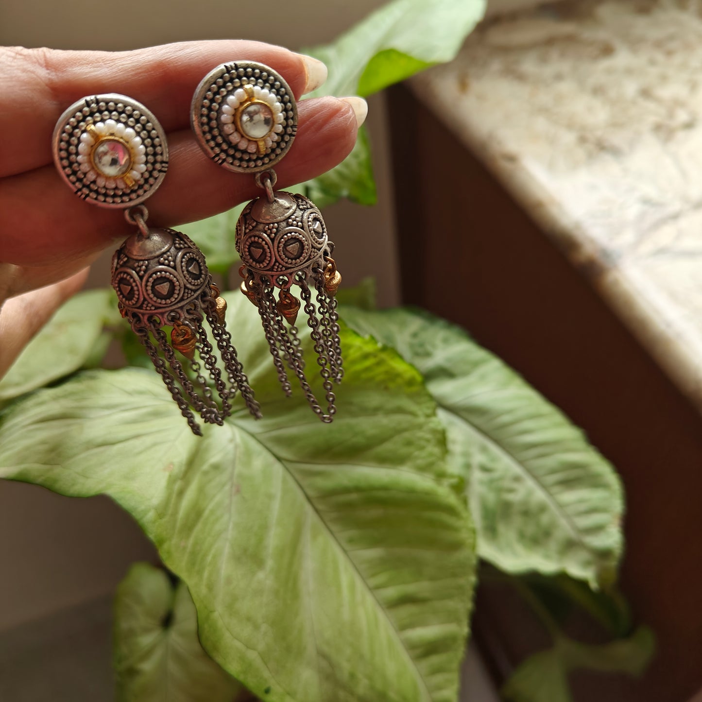 Dual tone jhumkis(earrings)with stone,pearls and chains