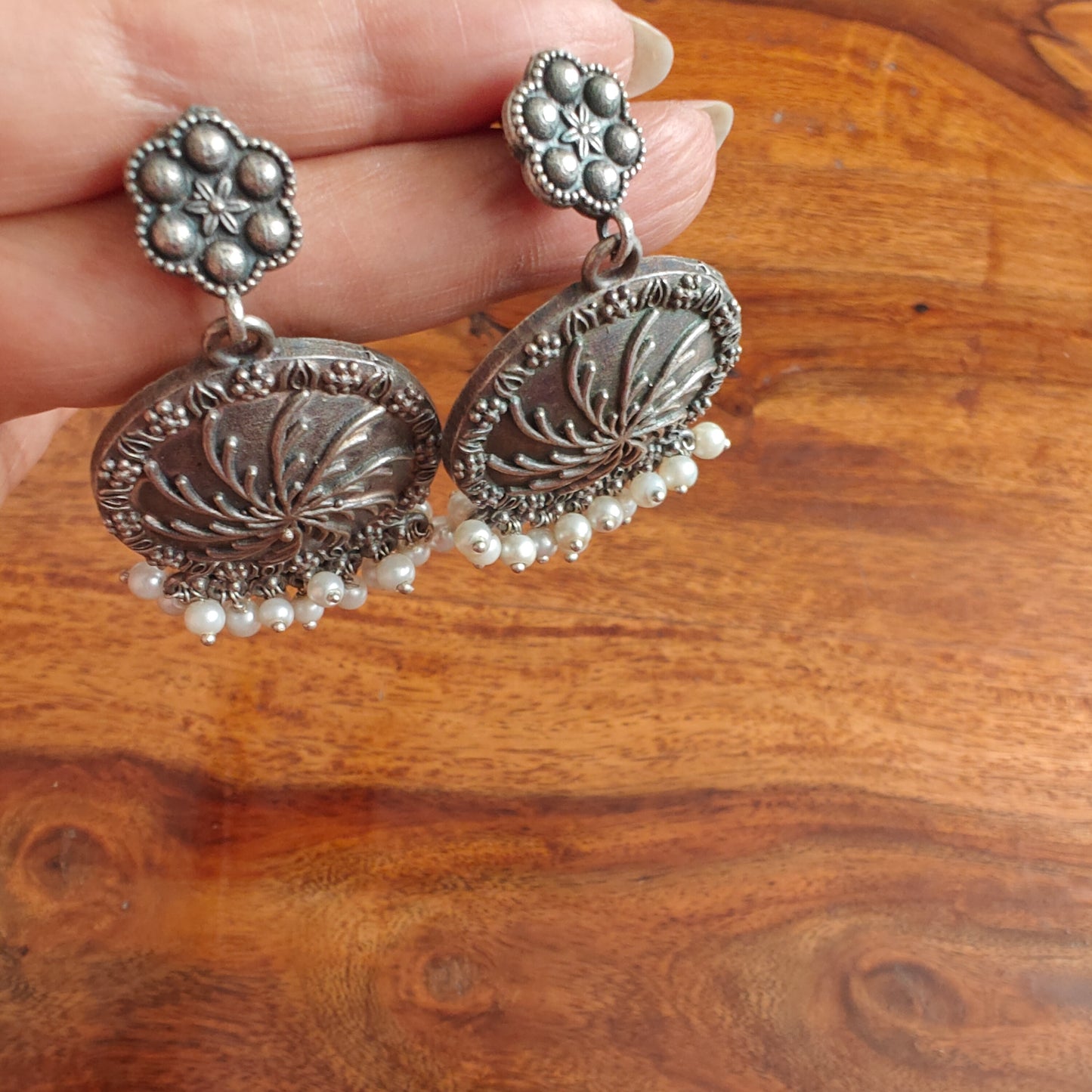 Engraved ferns on earrings and pearls below