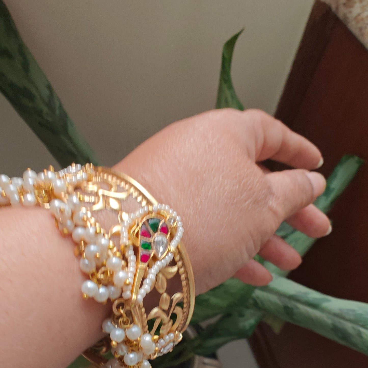 Golden kara with a bird motif and jali work