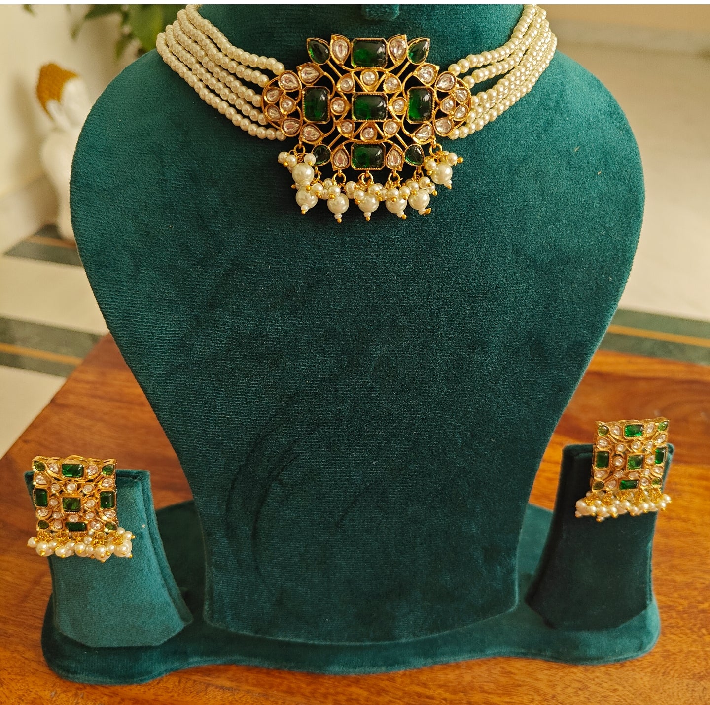 Rupashi choker set with emerald green stones and kundan
