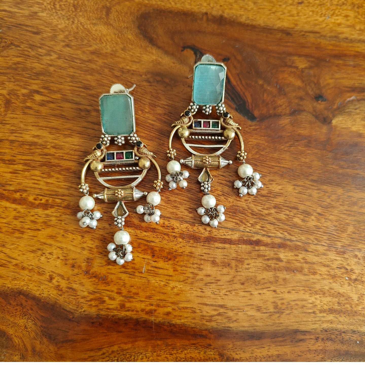 Dual tone earrings with birds and pearl hangings