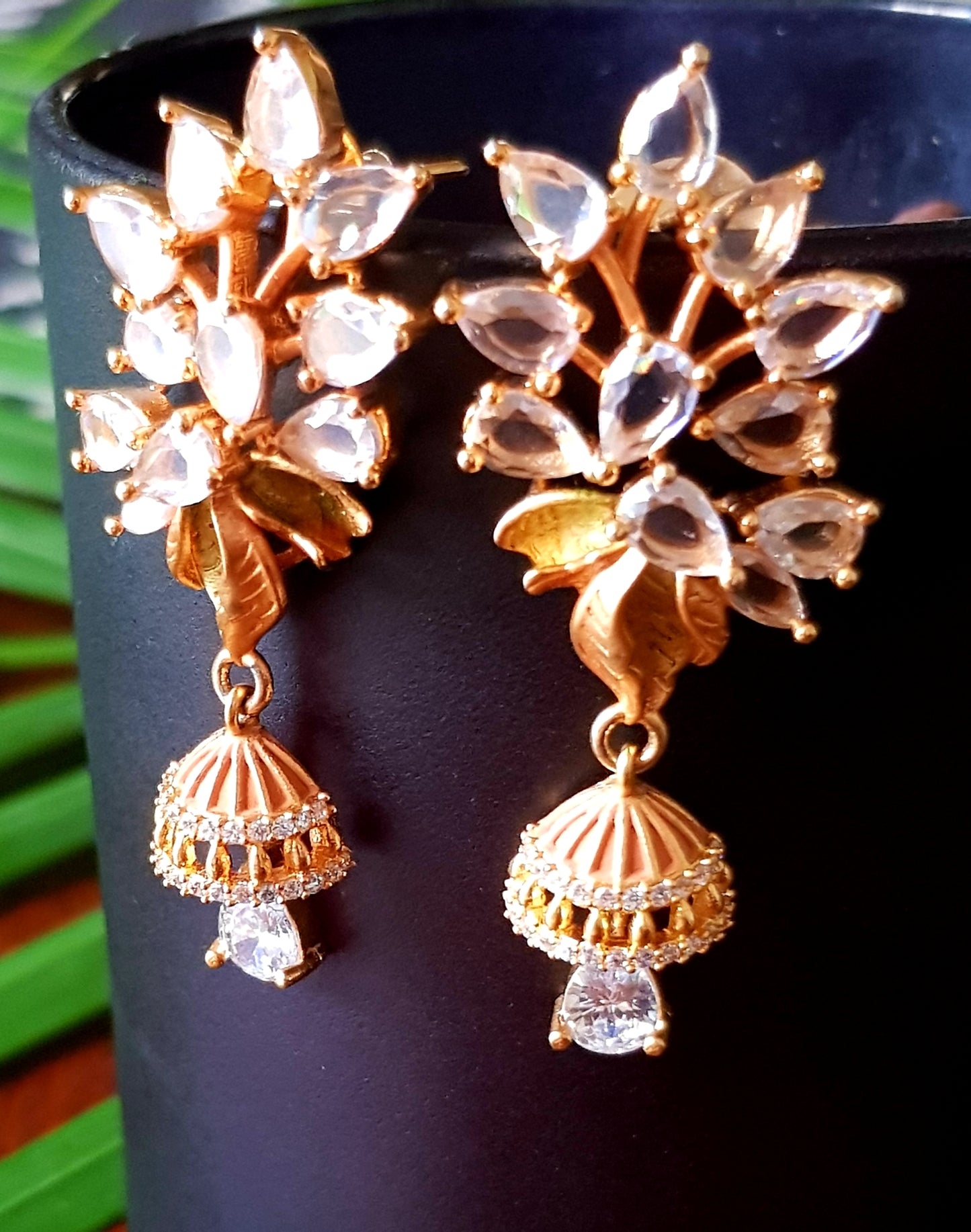 Gold finish flower design pendant set with clear stone and crystal hangings, matching earrings