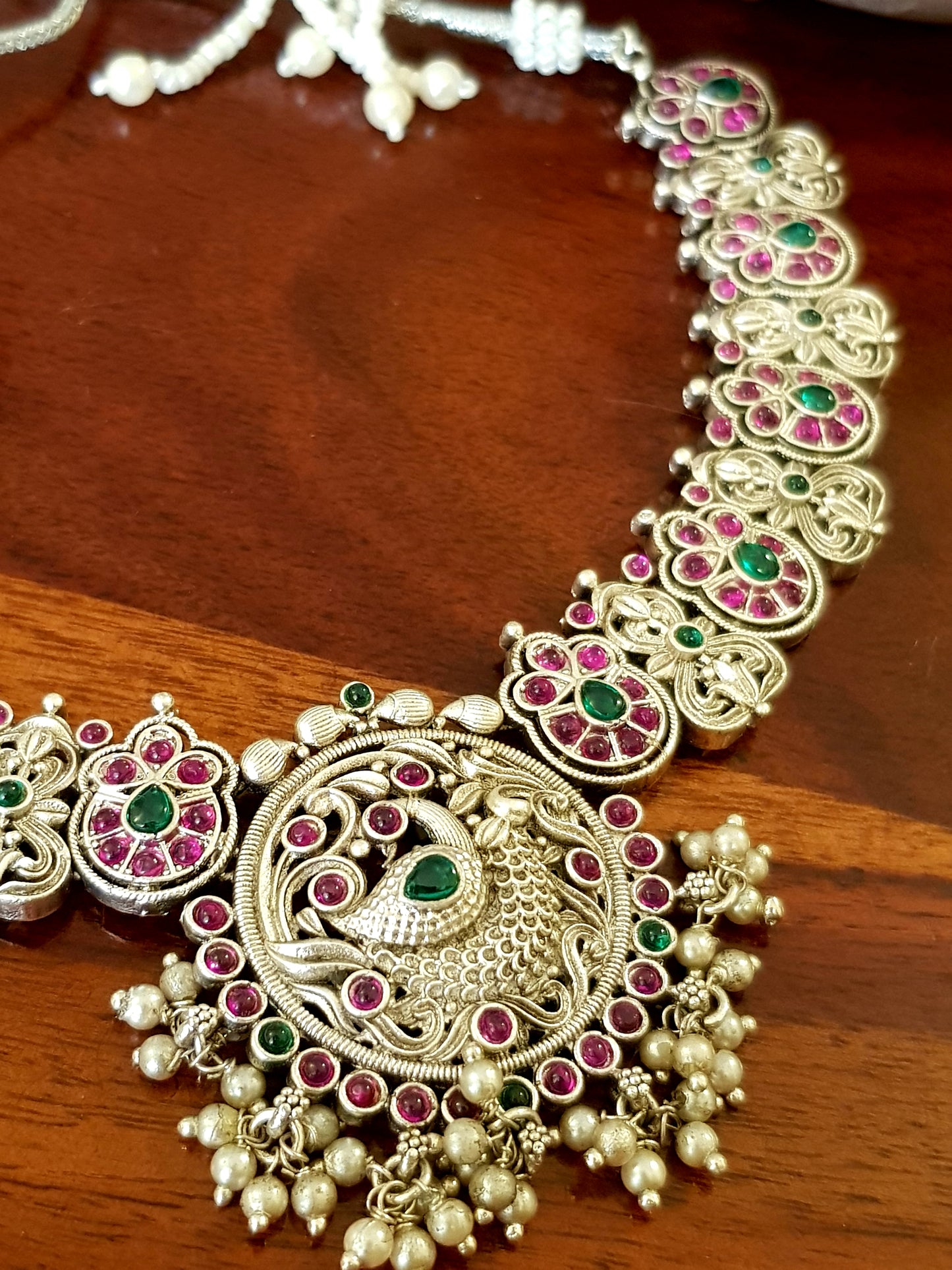 Silver finish temple jewelry set, peacock design necklace, green-red stones inlay, matching jhumkas (earrings)