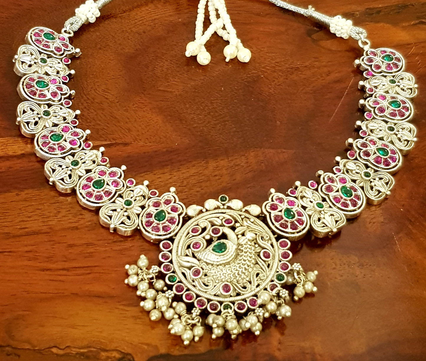 Silver finish temple jewelry set, peacock design necklace, green-red stones inlay, matching jhumkas (earrings)