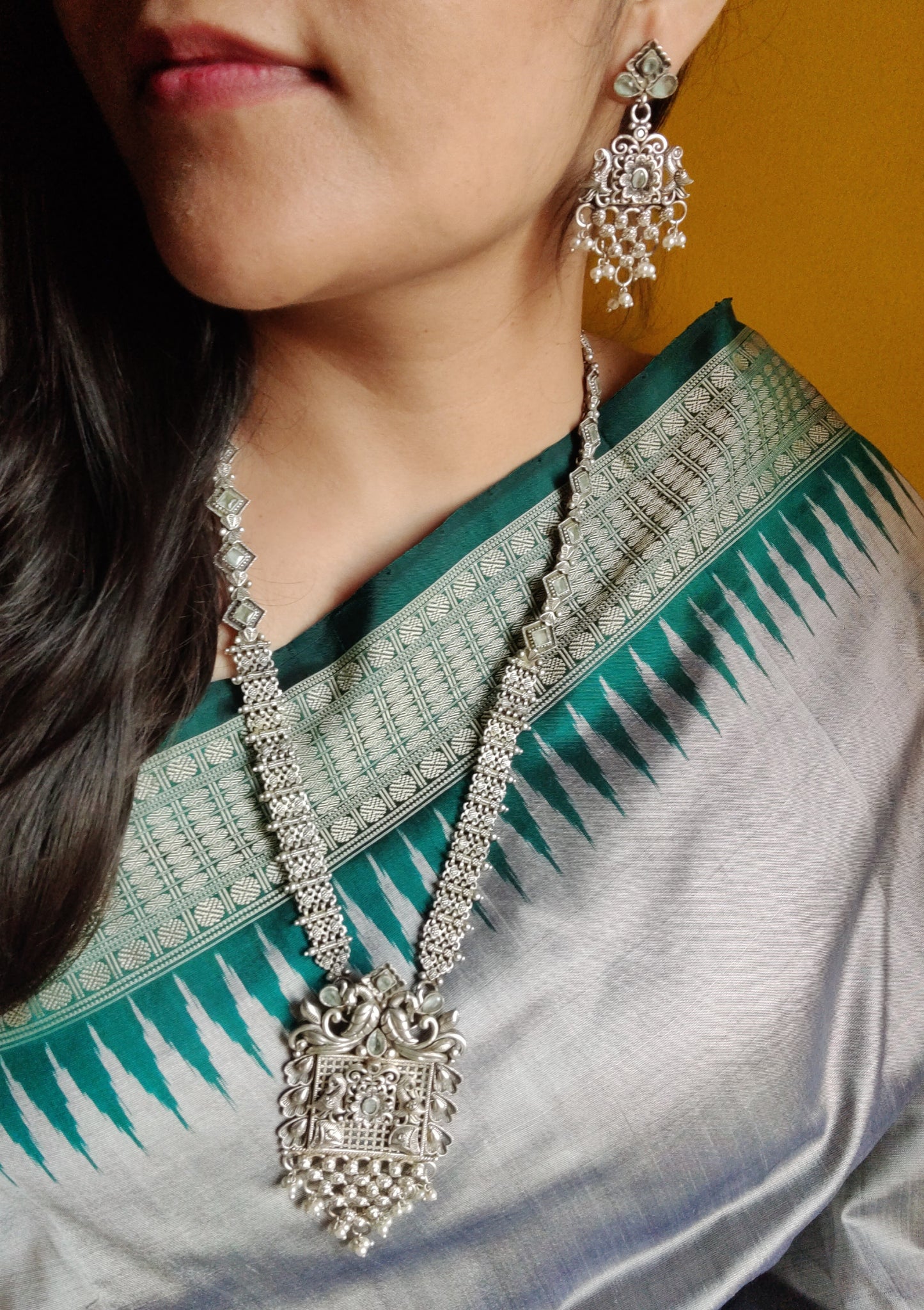 Silver finish set, long necklace with intricate work and pale pink/mint green detailing, matching earrings