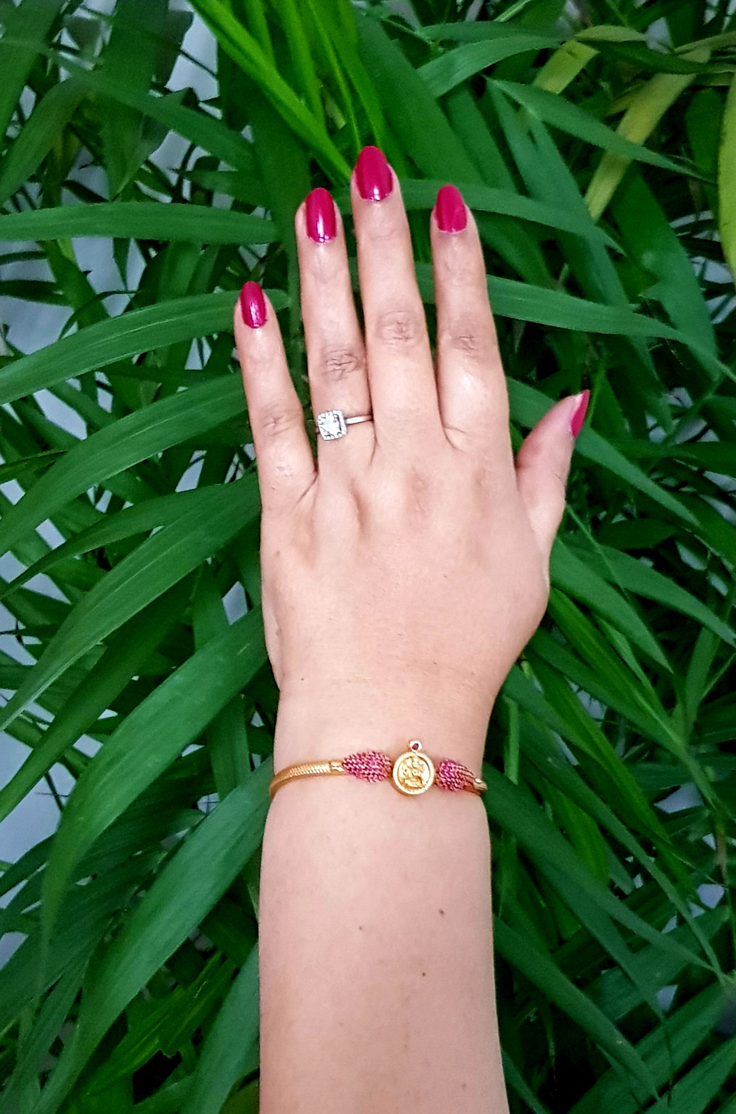 Temple jewelry gold finish bracelet with lakshmi motif and ruby stone detailing